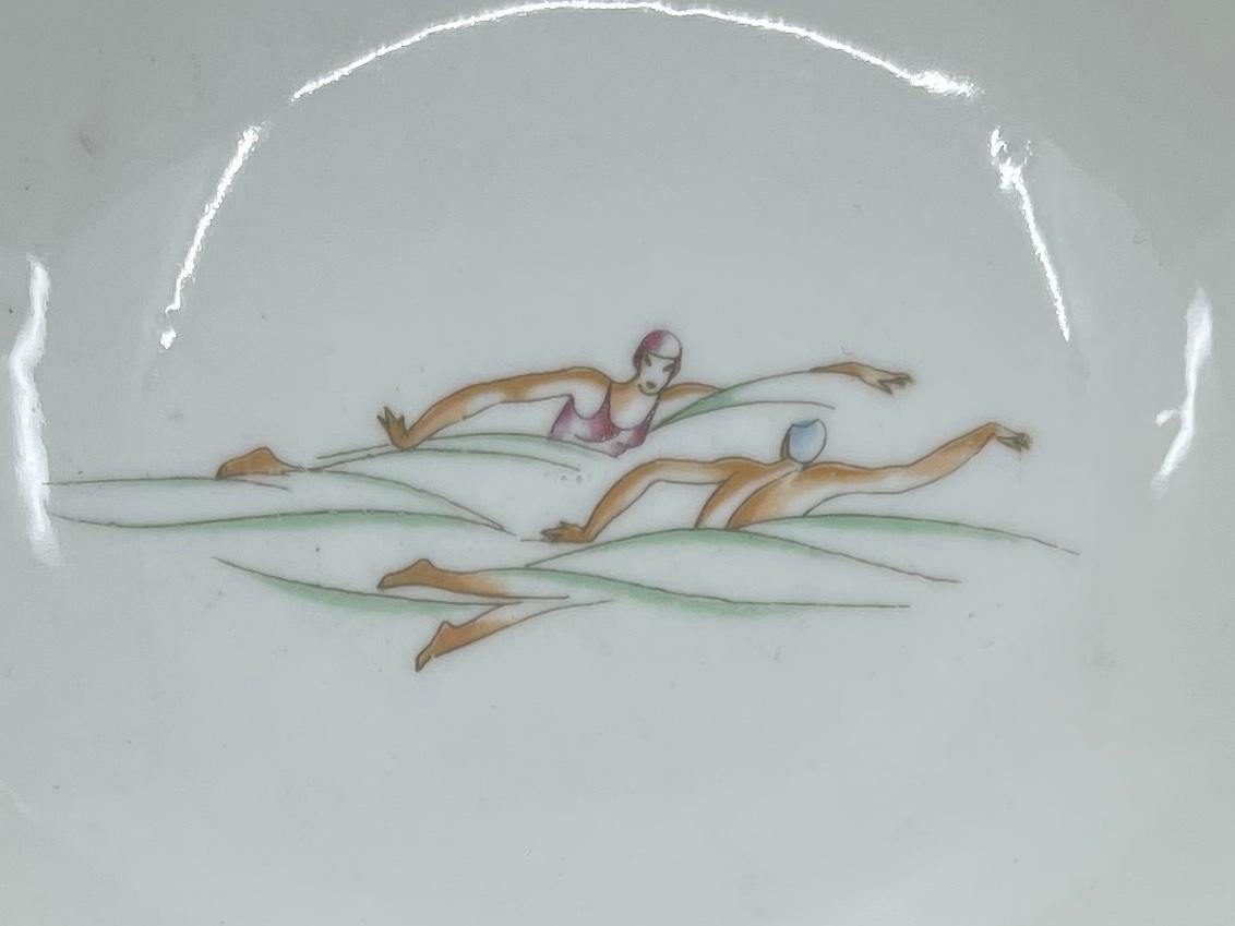 Gio Ponti for Ginori athletic dish. Vintage Richard Ginori shaped nut dish/ small saucer from the athletic series designed by Gio Ponti featuring a pair of female swimmers in competition. Italy, circa 1930's
Dimensions: 5