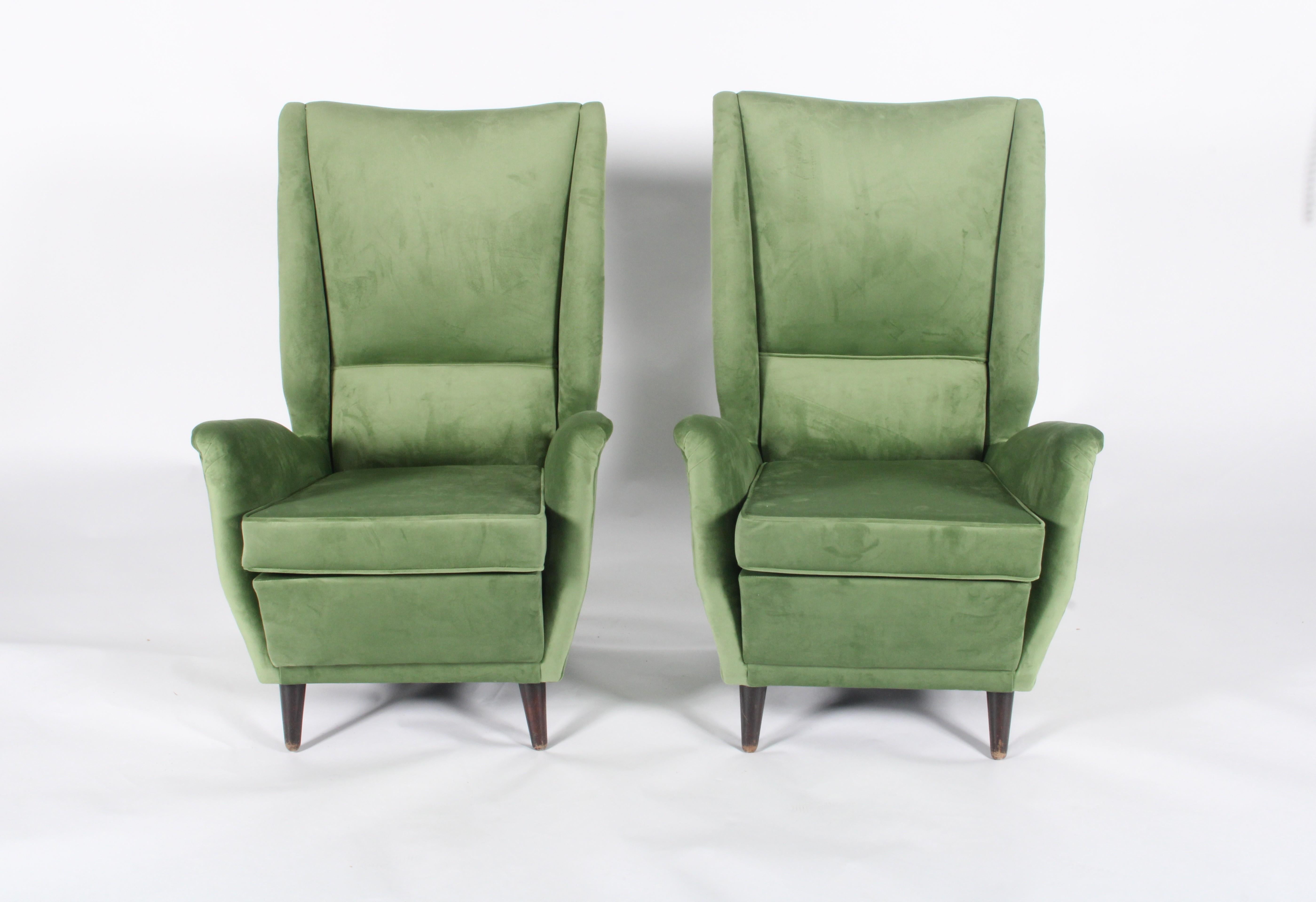 These exquisite mid-century modern Italian armchairs, attributed to the legendary Gio Ponti for Issa Bergamo, date back to circa 1955. A true testament to Ponti’s visionary design, these chairs feature sculptural lines, a high winged back, and