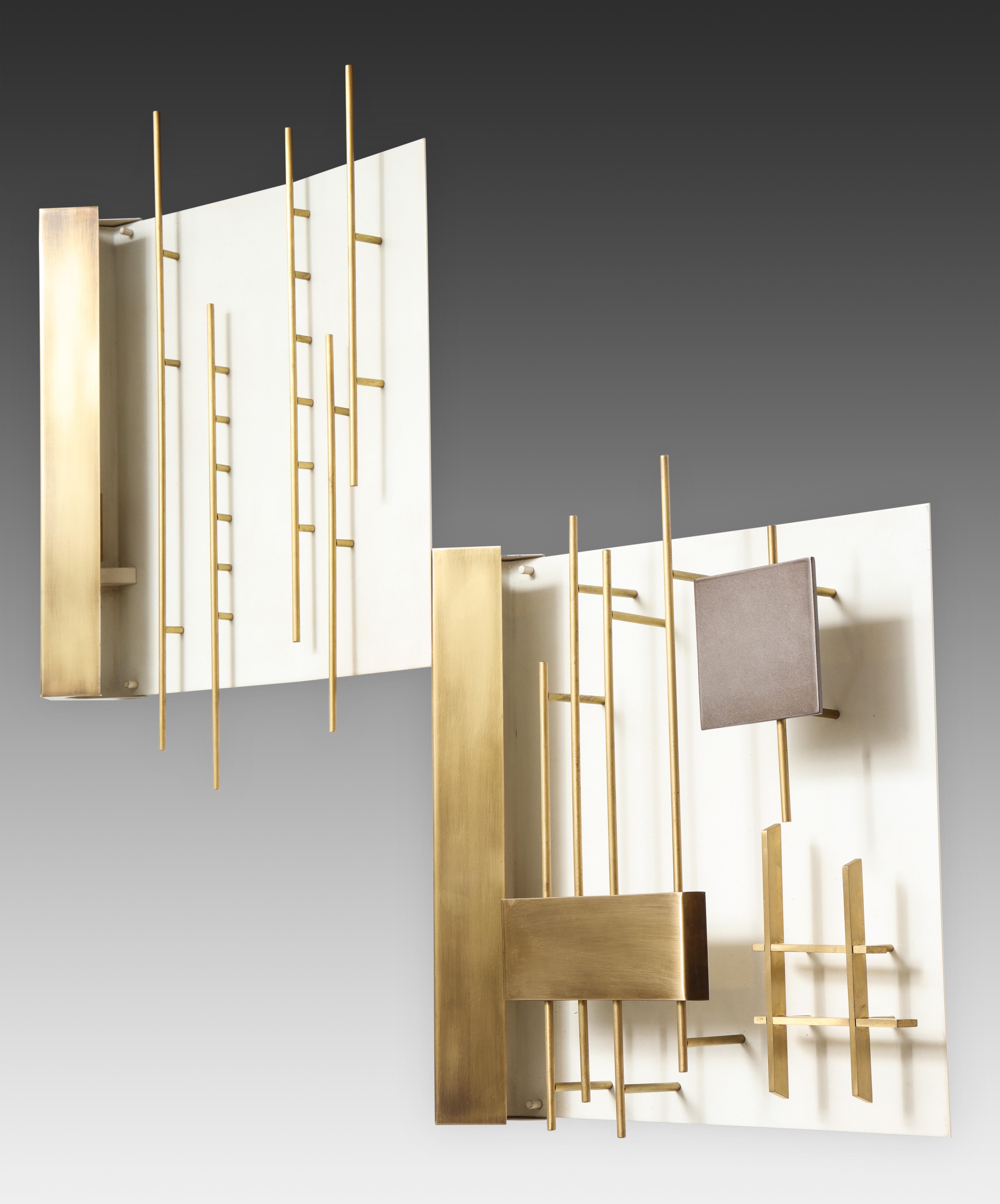 Designed by Gio Ponti for Lumi, rare pair of first edition 'Quadri Luminosi' sconces models 575 and 576, Italy, circa 1960. Brass and enameled brass architectural rods and geometric shapes sculpturally mounted on white enameled metal. The light