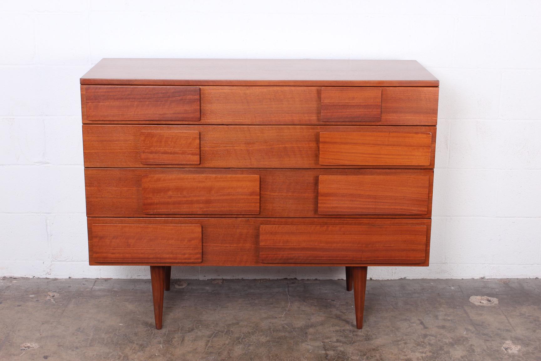 A rare walnut chest of drawers designed by Gio Ponti for Singer & Sons. Signed with decal to drawer interior.