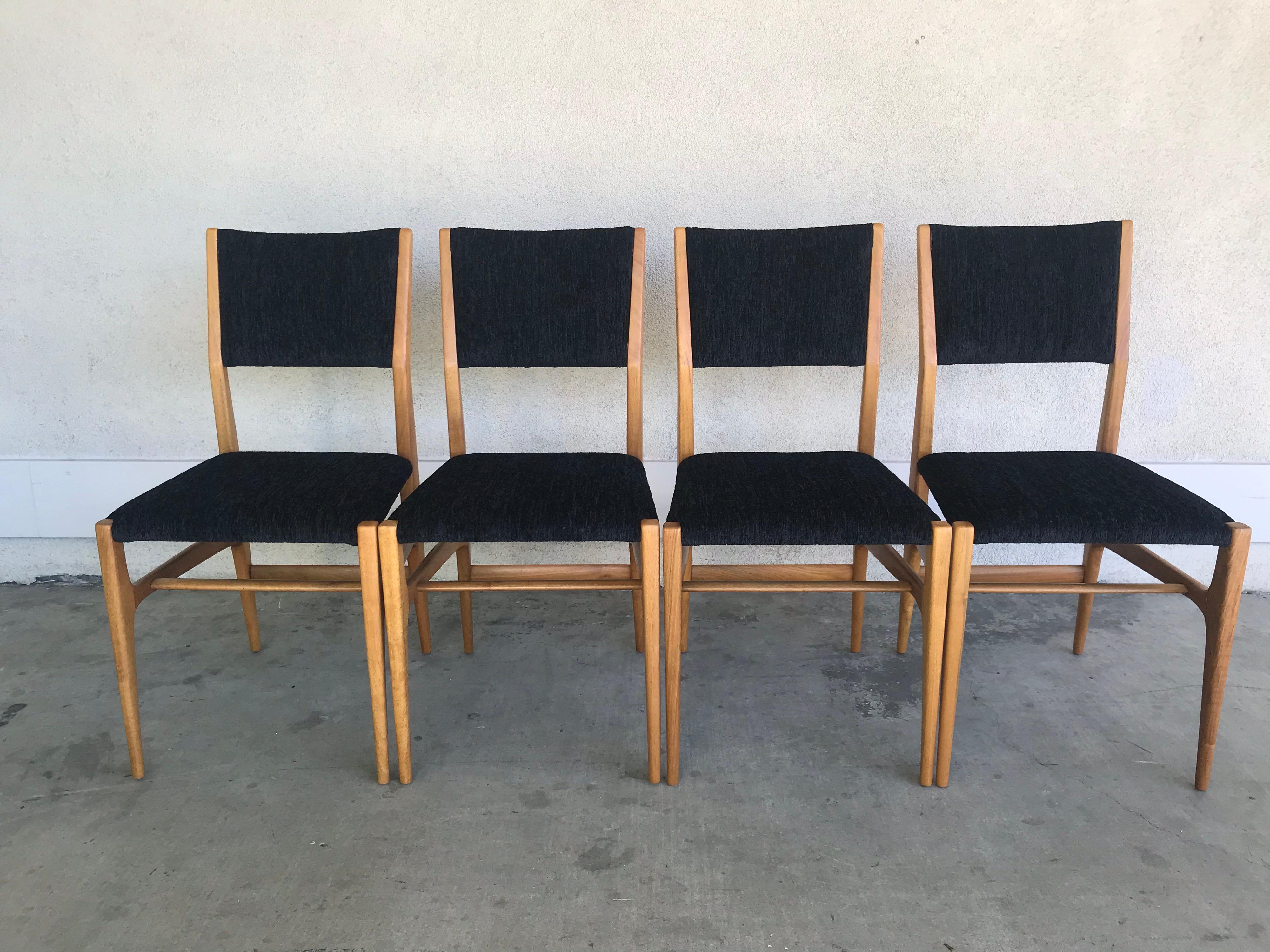 An elegant and timeless design.
Made of Italian walnut with sensuous lines and new chic black textured upholstery.
The wood has been lightly cleaned (not refinished) without taking away from its' historical integrity.
These are great with a