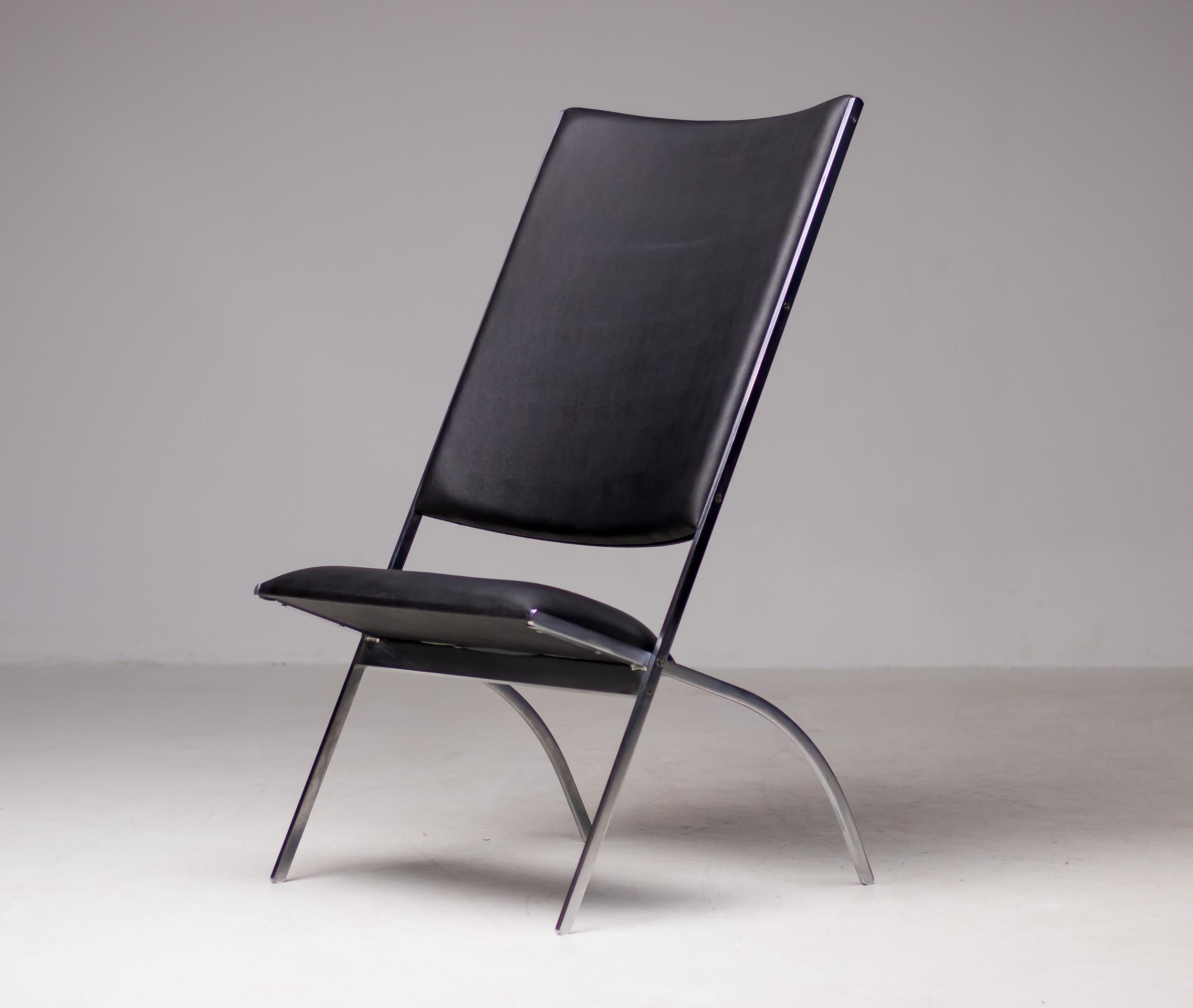 Gabriella folding lounge chair with a steel frame, seat, and back upholstered in black Naugahyde.  
This iconic chair was designed by the Italian designer Gio Ponti and released in a limited edition of 100 pieces by Paolo Pallucco in 1991.  This