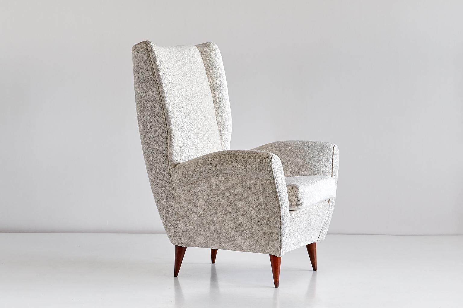 This high back armchair was designed by Gio Ponti for a private commission in the late 1940s. The chair is characterized by its strikingly modern lines, elegantly tapered walnut legs and generous proportions. 
The comfortable armchair has been