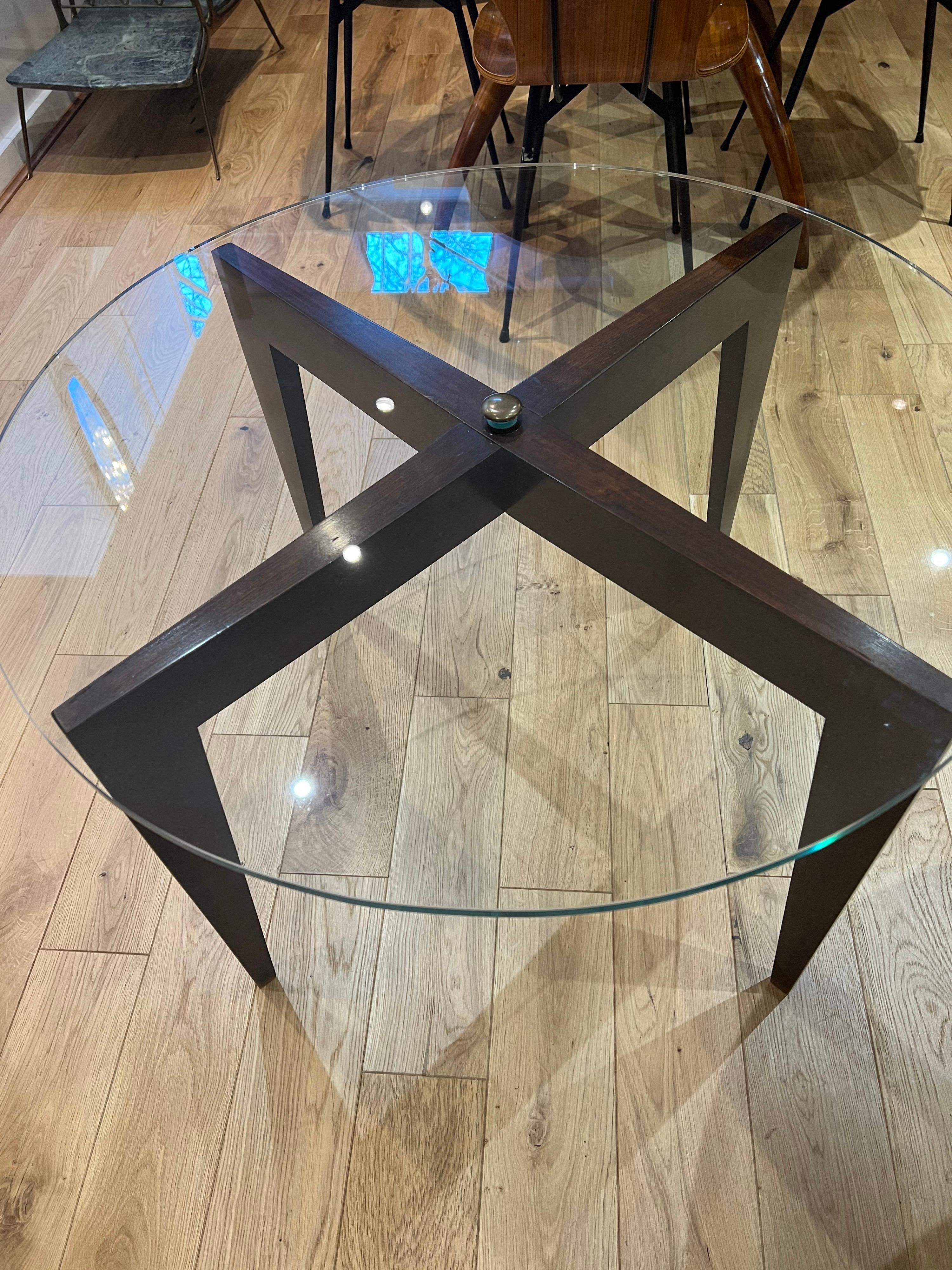 An original X form iconic Gio Ponti table in cherry wood with a circular glass top for Fondazione Garzanti di Forli - Interiors. This fabulous piece was in the private collection of the Ponti family in Florence and comes with a signed certificate of