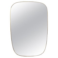 Gio Ponti, dans le style de. Miroir encadré de laiton doré. Années 1980