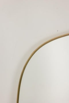 Gio Ponti, in the style of. Pair of mirrors framed in gilt brass. 1980s