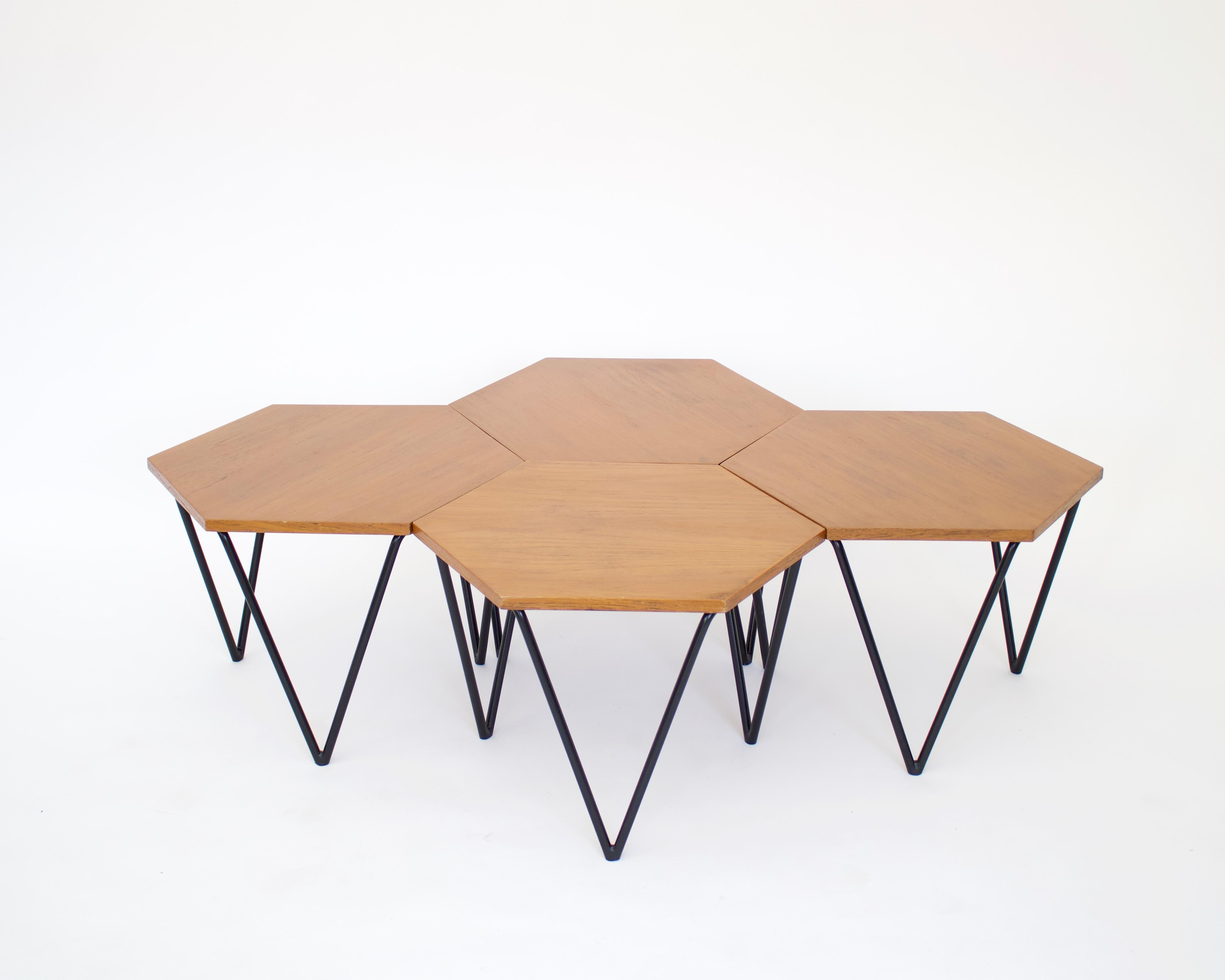 Modular segmented coffee tables designed by Gio Ponti . 7 identical tables either made of wood, black or white laminate. Each had a honeycomb shape and three triangular legs, and can be used as a coffee table or side tables. The metal bases have