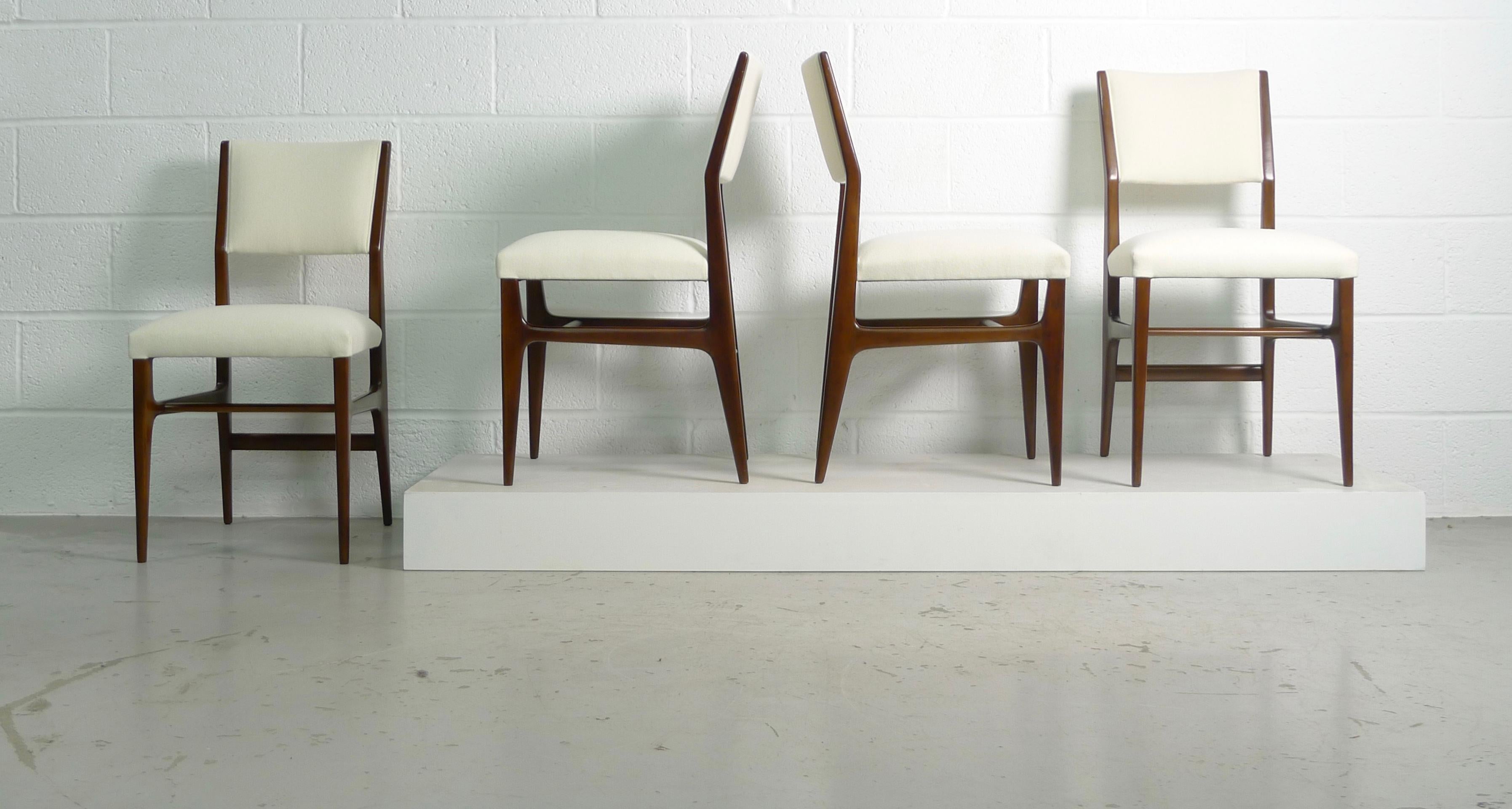Gio Ponti designed set of 4 dining or side chairs, made in Italy for Singer & Sons of New York, 

Model #116 with newly restored dark walnut frames and seats and backs newly reupholstered in Kvadrat cream wool . 

2 of the chairs have the