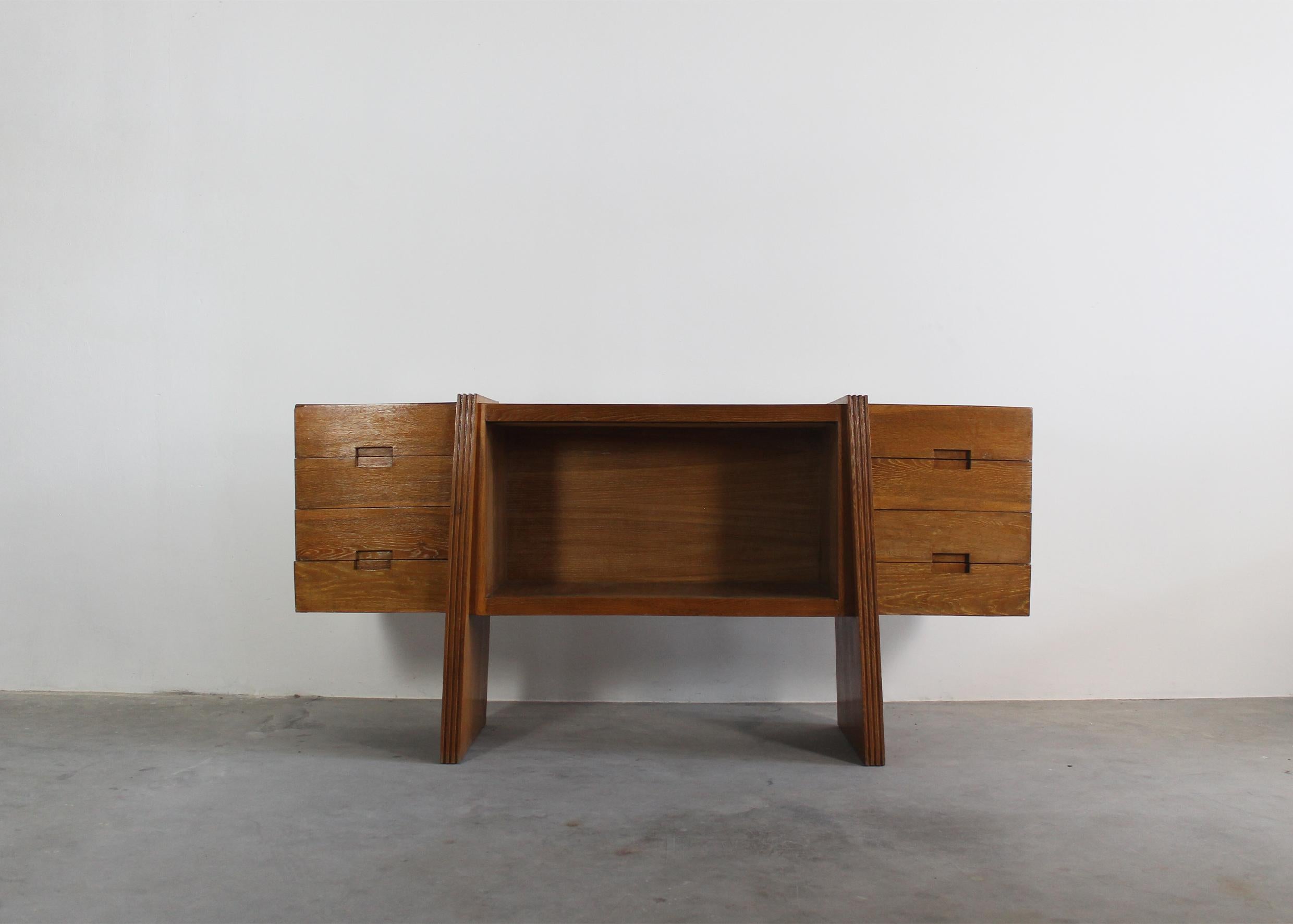 Large sideboard is entirely realized in oak wood, with four drawers on each side (for a total of eight drawers) and a central storage unit. 

Designed by Pier Luigi Colli Italian Manufacture from 1938 ca.

To reconstruct the story of Pier Luigi