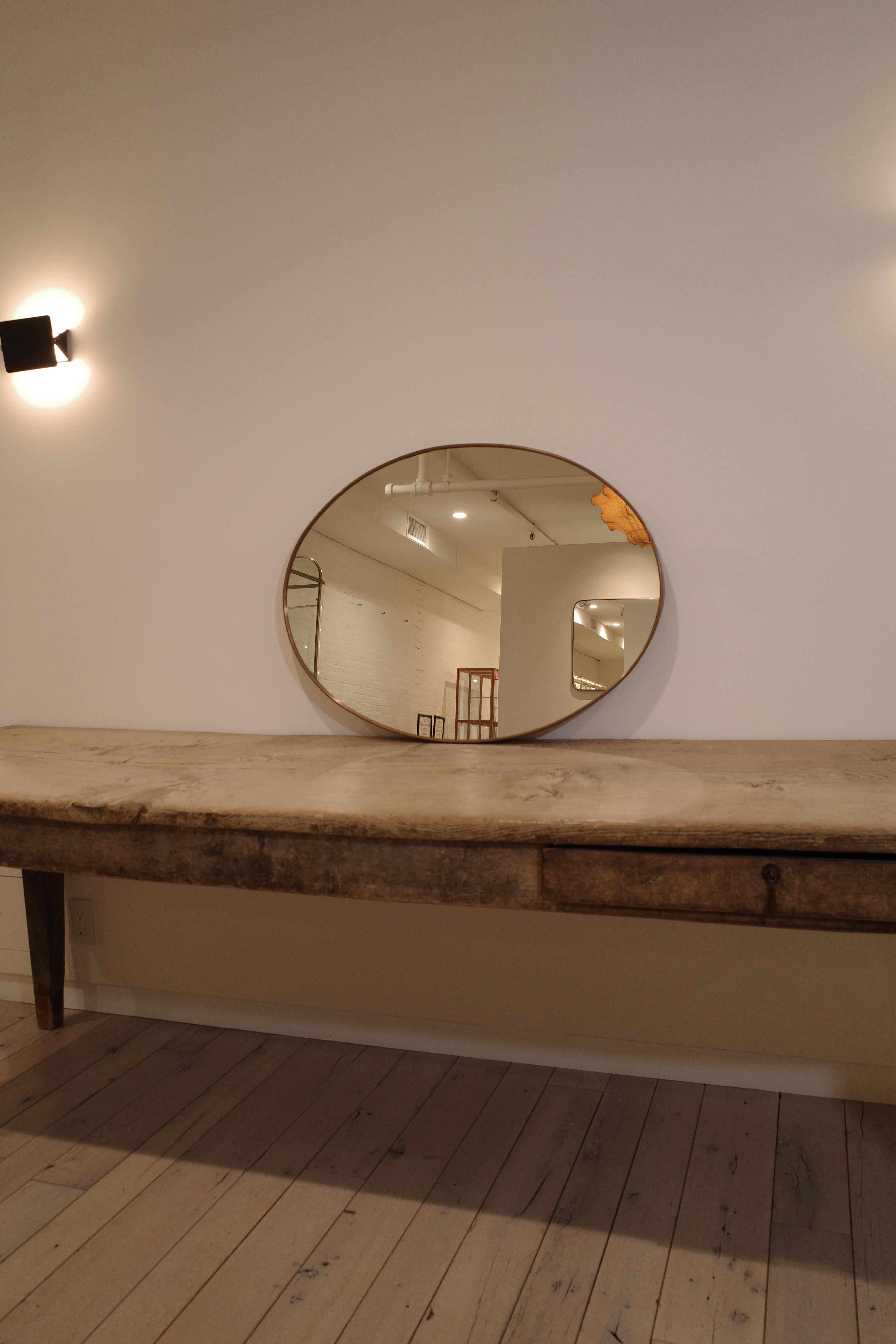 An exquisite example of Italian Mid-Century Modern design, this large wall mirror was created by the legendary architect and designer Gio Ponti for the prestigious manufacturer Fontana Arte around the 1950s. This iconic piece, a testament to Ponti's