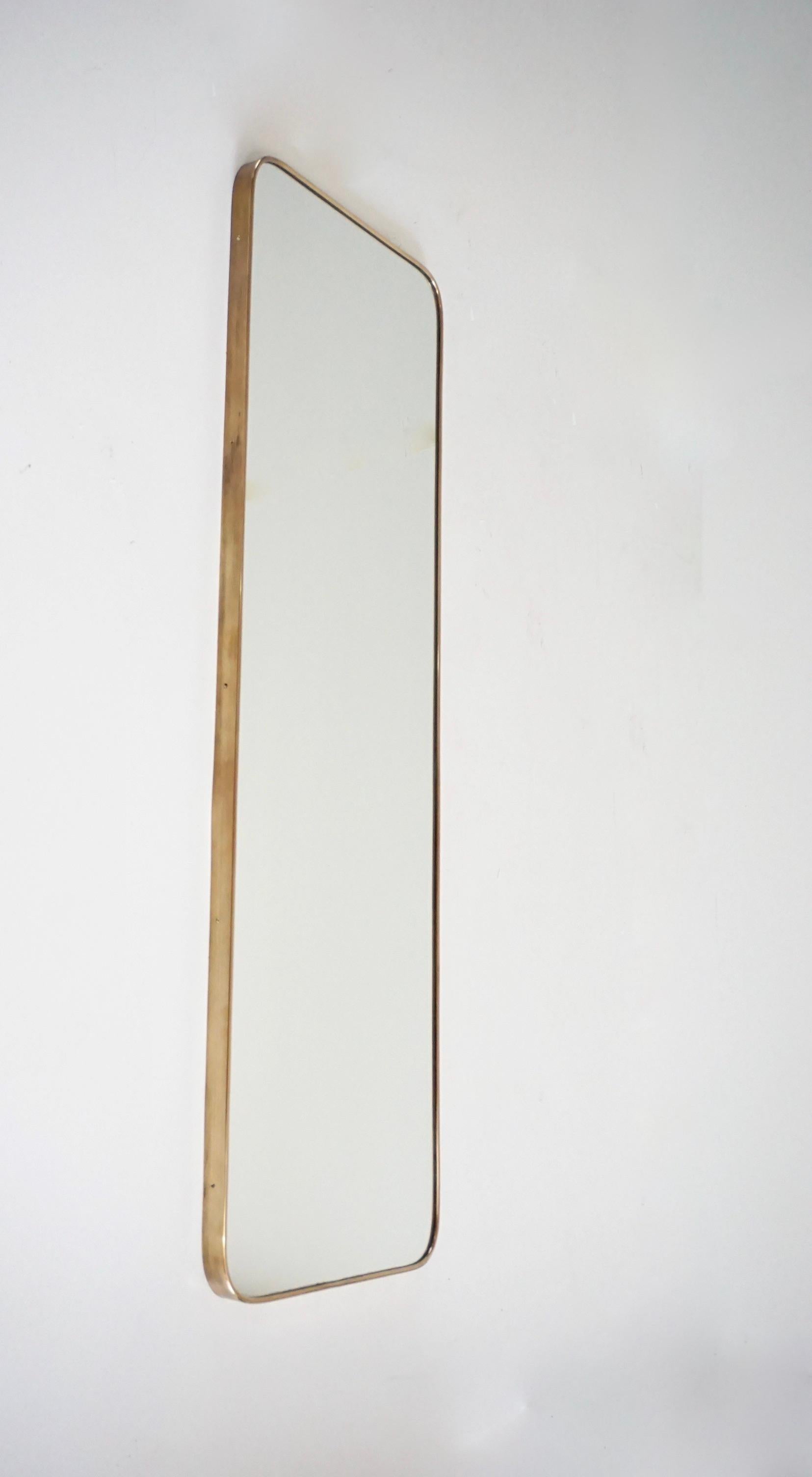 Gio Ponti wall mirror from the original furniture of the hotel Royal  Rome, 1955. 
Manufactured by Fontana Arte. 
Measures: H 138 cm, 46 x 3.5 
Brass, mirror and ash.
Designed as a vertical wall mirror, it can also be used in a horizontal version