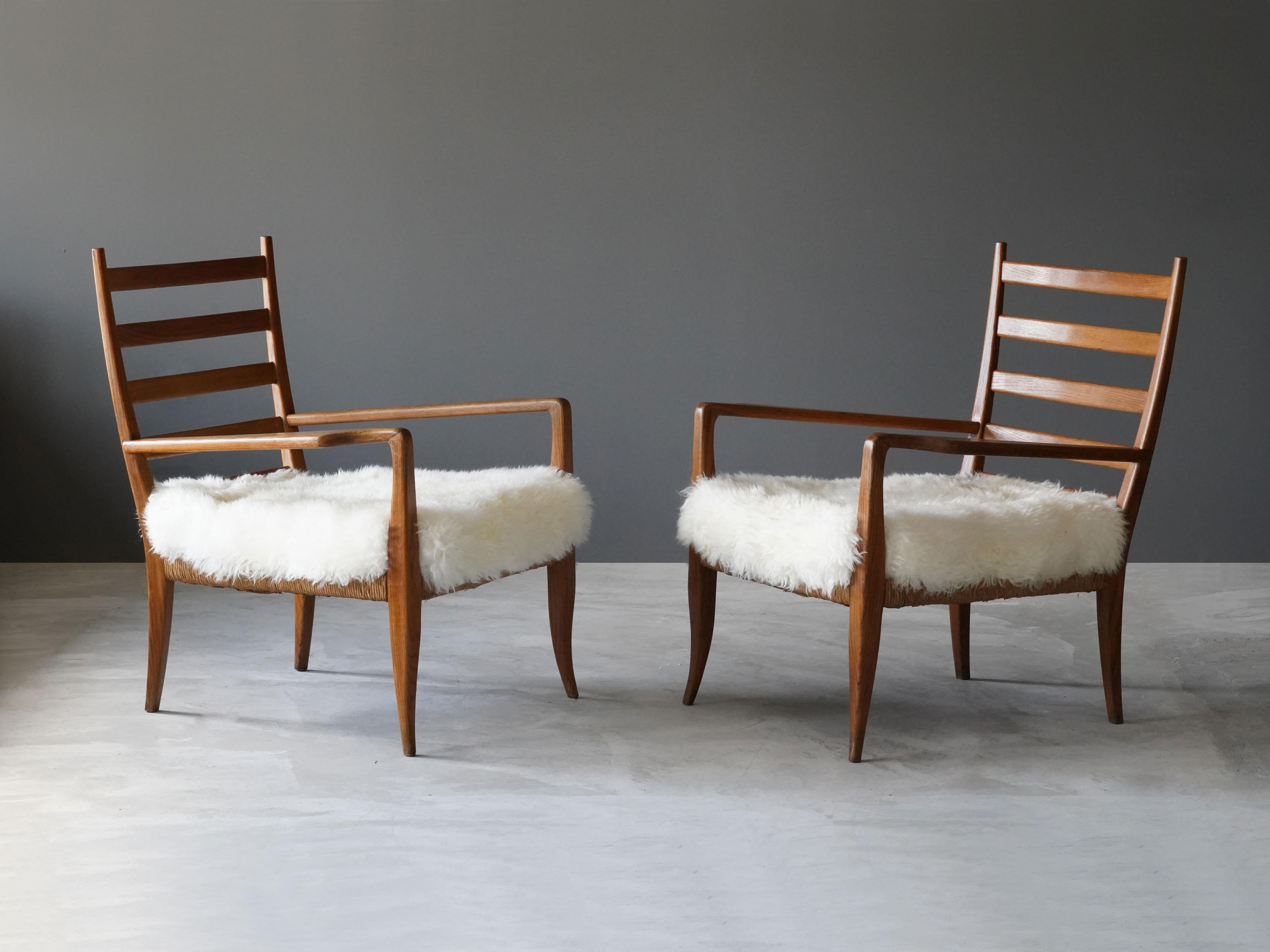 A pair of lounge chairs designed by Gio Ponti for La Rinascente, the high-end Milan department store. Produced in the 1930s. The ash frame has a rush seat, and placed atop a lambskin cushion. 

The pair is sold with a certificate from the Gio Ponti