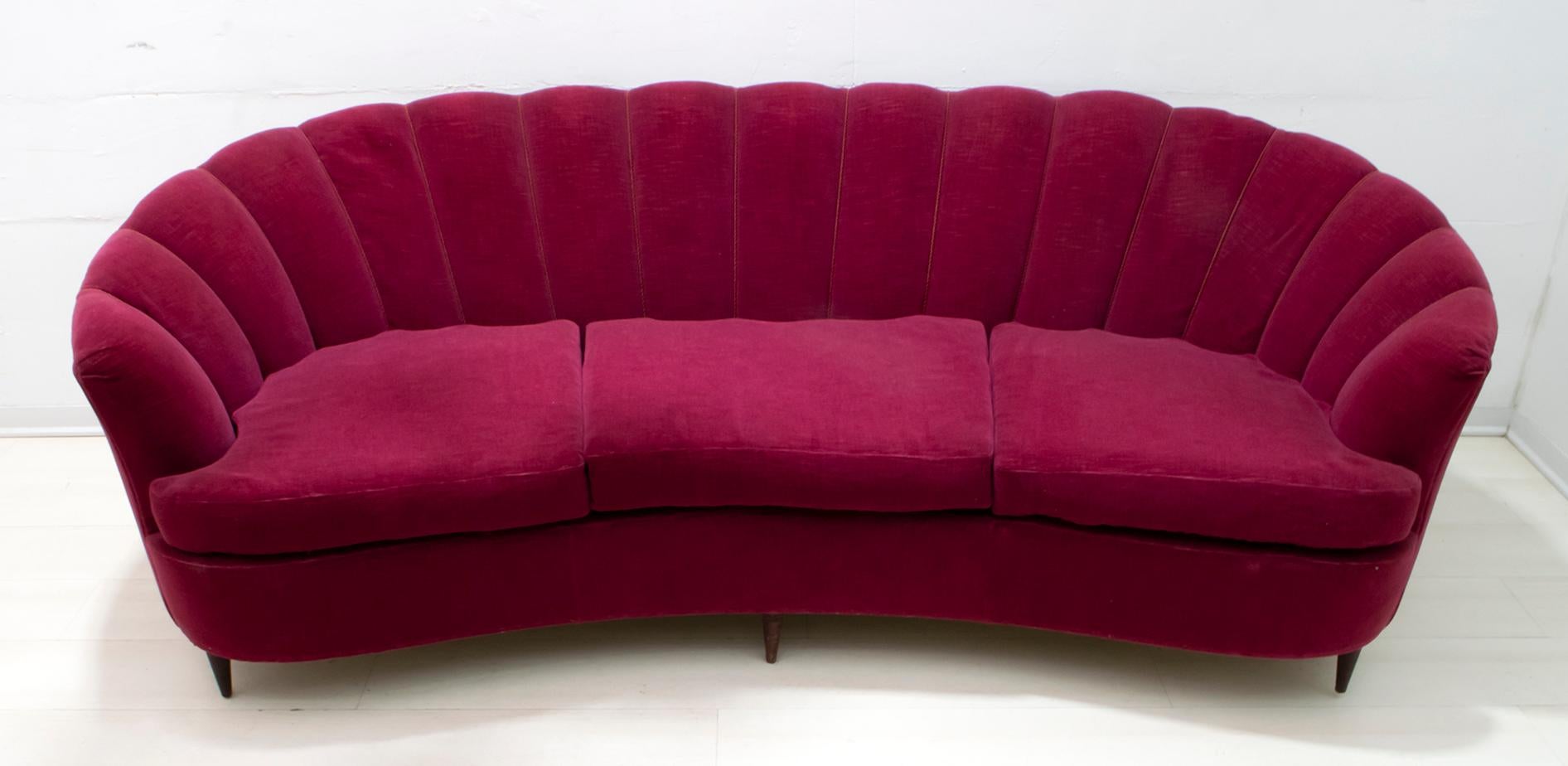A rare sofa by Gio Ponti for Casa e, 1936.
Shell model covered in amarando red velvet, original of the time. The coating, as shown in the photo, is slightly worn. It is recommended to redo the coating.

With an additional cost we can provide for
