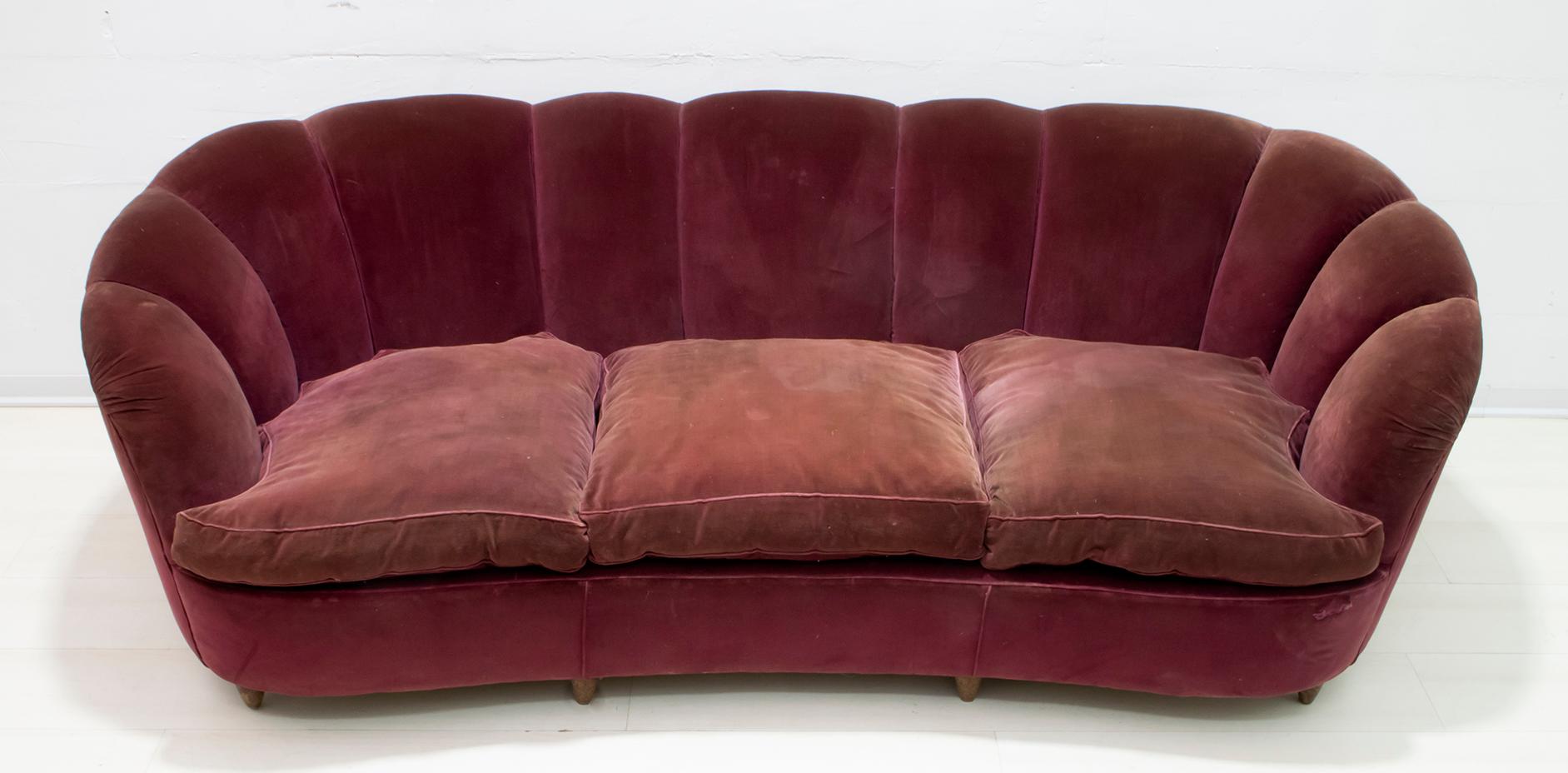 A rare sofa by Gio Ponti for Casa e Giardino, 1936.
Shell model covered in original velvet of the time, with goose down cushions. The coating, as shown in the photo, has faded in some parts and worn out. It is recommended to redo the