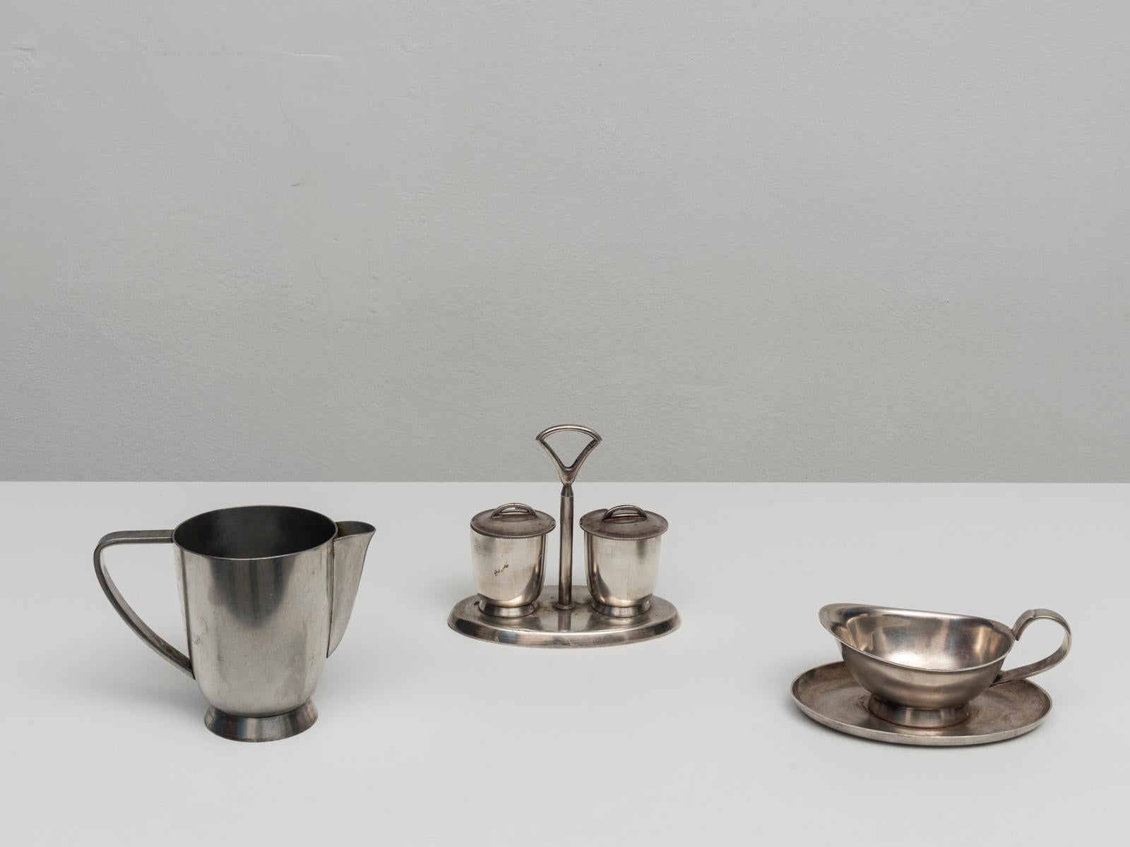 This serving set was designed by Gio Ponti for Fratelli Calderoni in the 1950s. It is made of silver plated alpaca, an alloy of copper zinc and nickel. 
The set includes a milk jug, a sauce bowl and a salt and pepper container. 
This series was