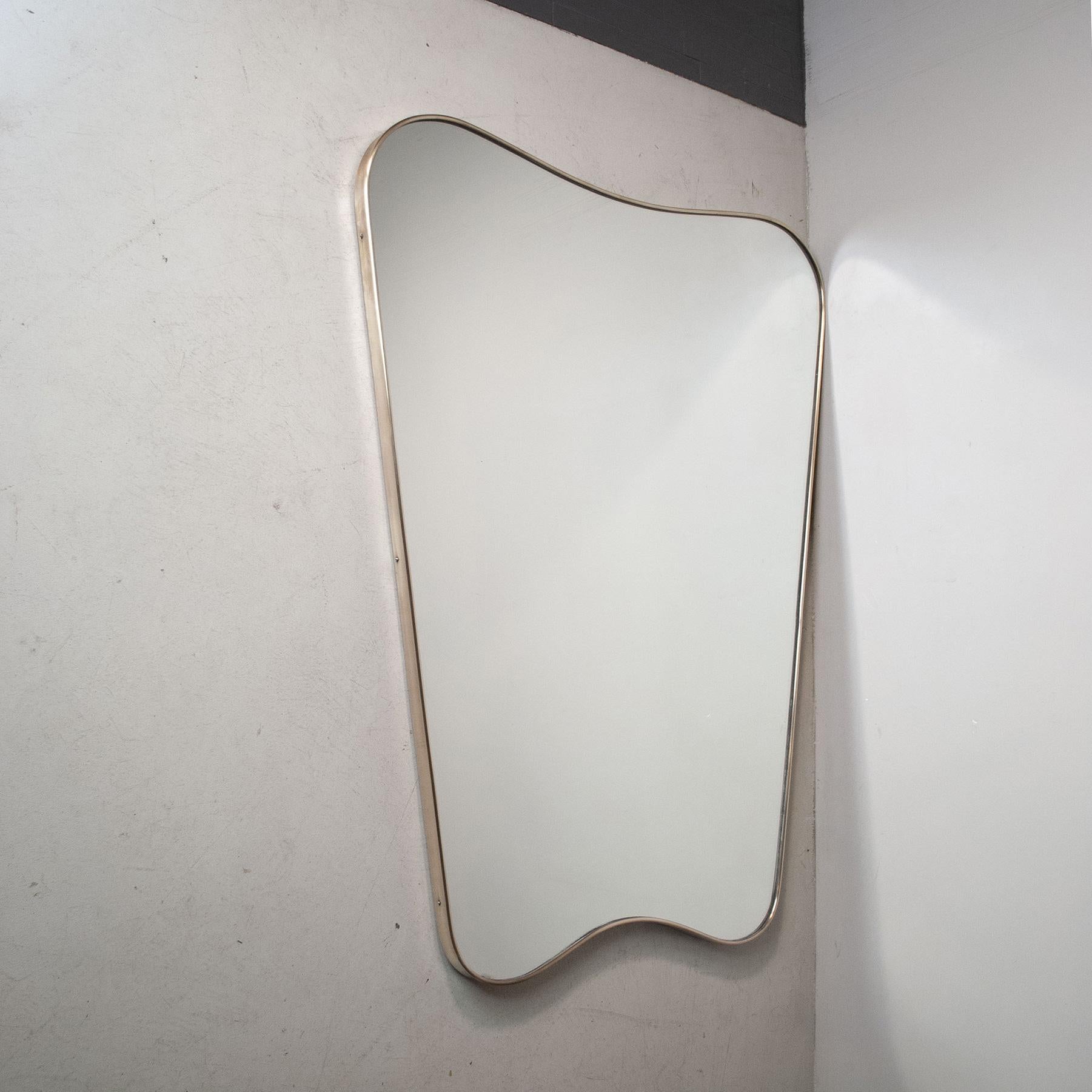 Stunning mirror of exceptional size for the type brass frame years in the Gio Ponti 1950s style.
