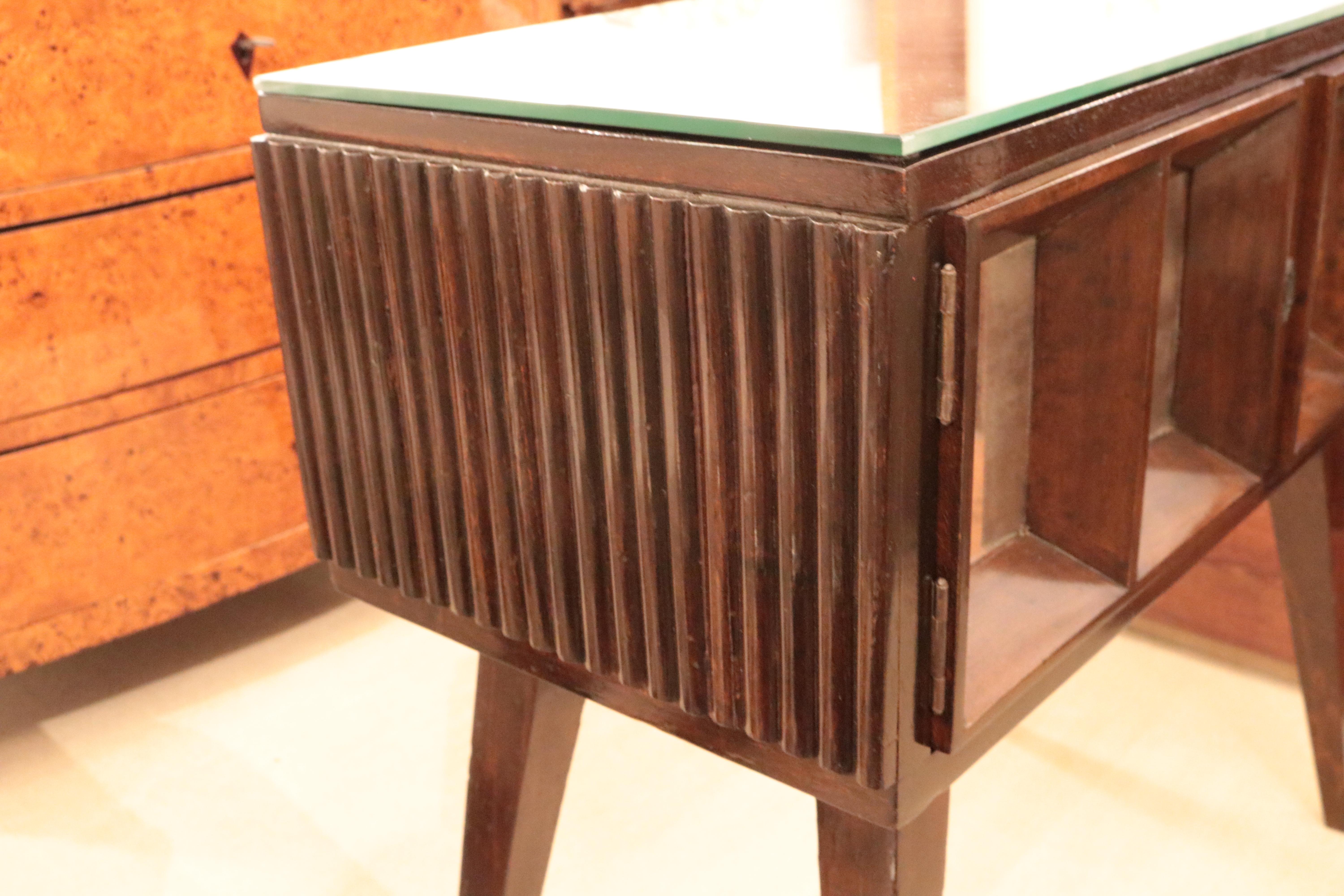 Gio Ponti Modernist two door cabinet. 
Stained walnut with mirrored door details and top.