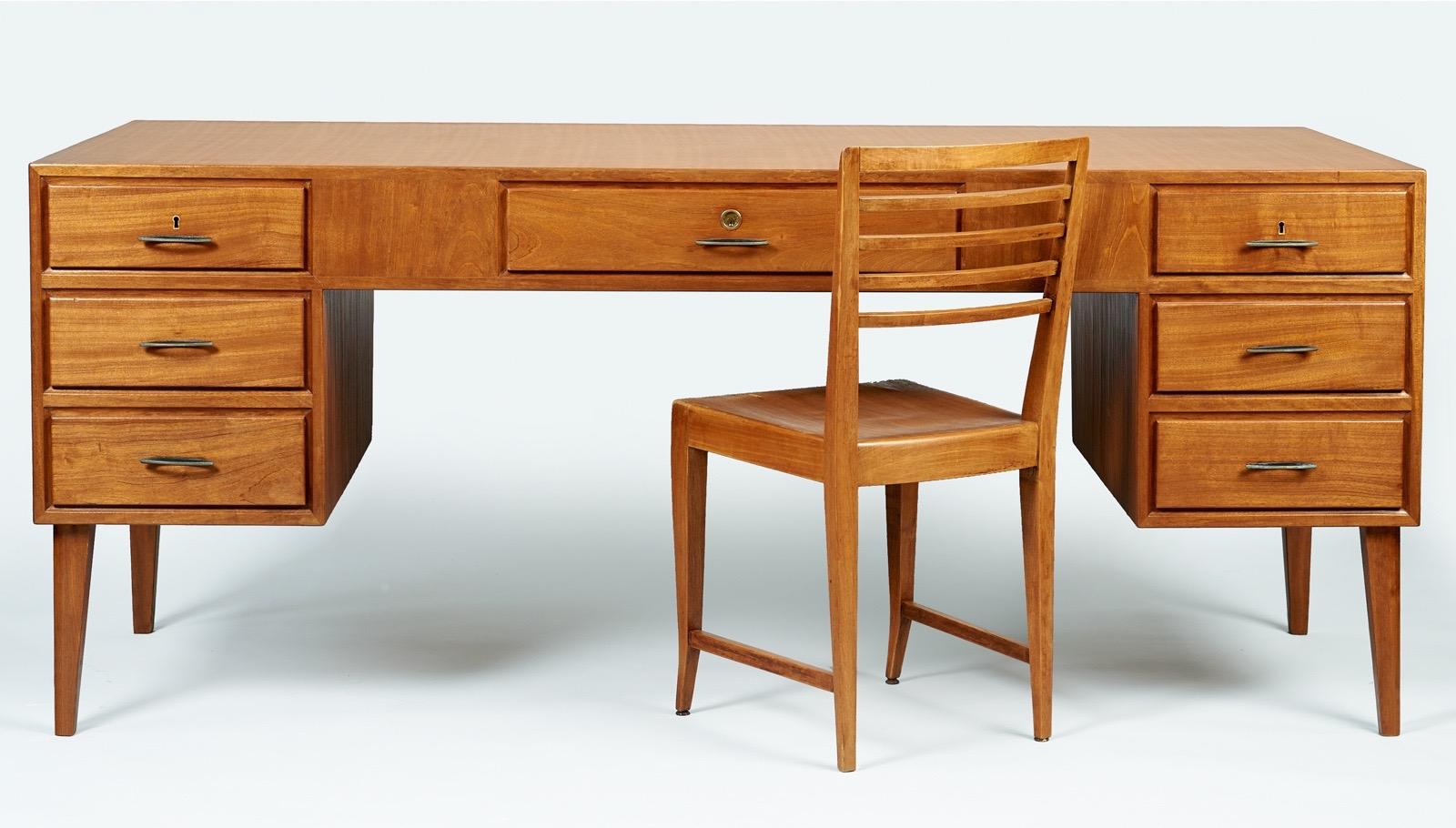 Gio Ponti (1891-1979)

An extremely rare and important desk set by Gio Ponti in reeded mahogany, comprised of an impeccably crafted floating desk, elegant desk chair, and matching geometric bookcase or end table. The architectural floating desk