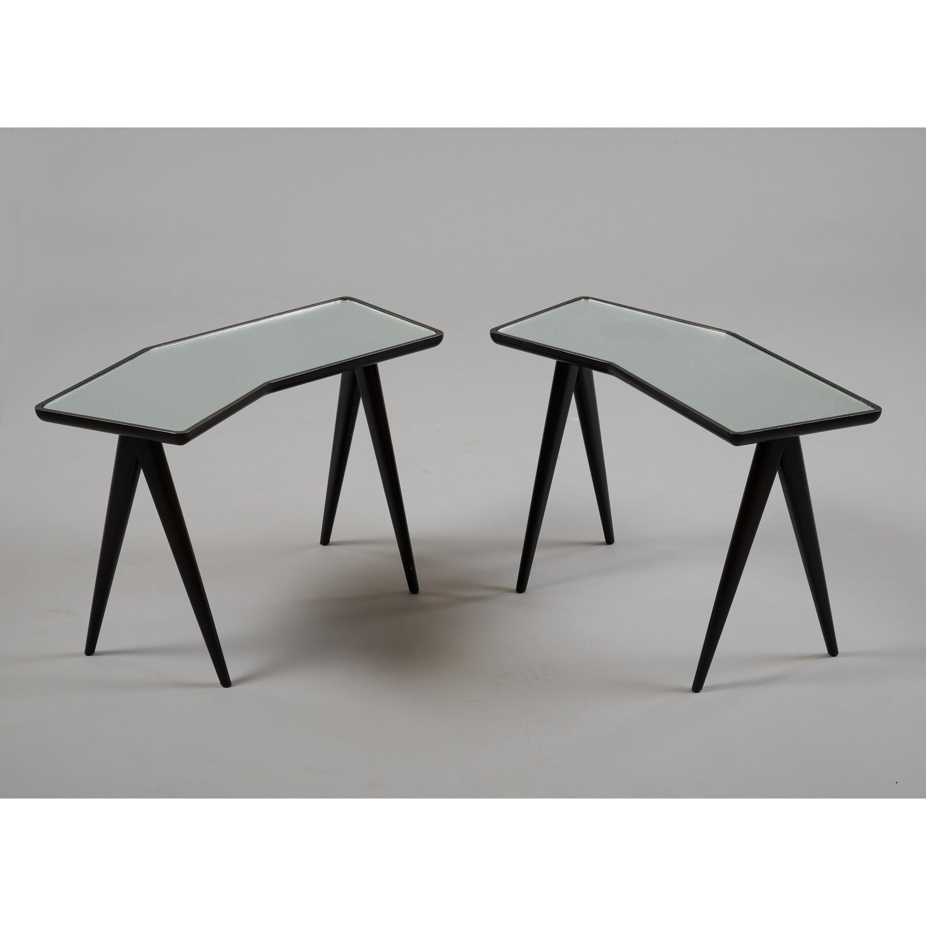 Gio Ponti (1891 - 1979) and Pietro Chiesa (1892 - 1948) 

A handsome pair of asymmetrical side tables by Gio Ponti and Pietro Chiesa for Fontana Arte. A geometric frame in ebonized walnut cradles an irregular hexagonal mirrored top, raised on a