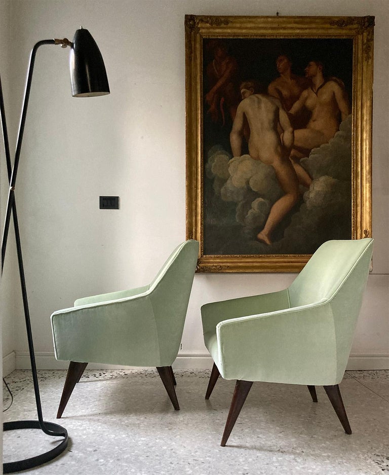 Pair of rare armchairs designed by Gio Ponti in 1960s.
The shape with typical geometric Gio Ponti pattern together with harmonic proportions and walnut beautiful inclined legs ,
characterize this couple of elegant armchairs. 
Reupholstered with