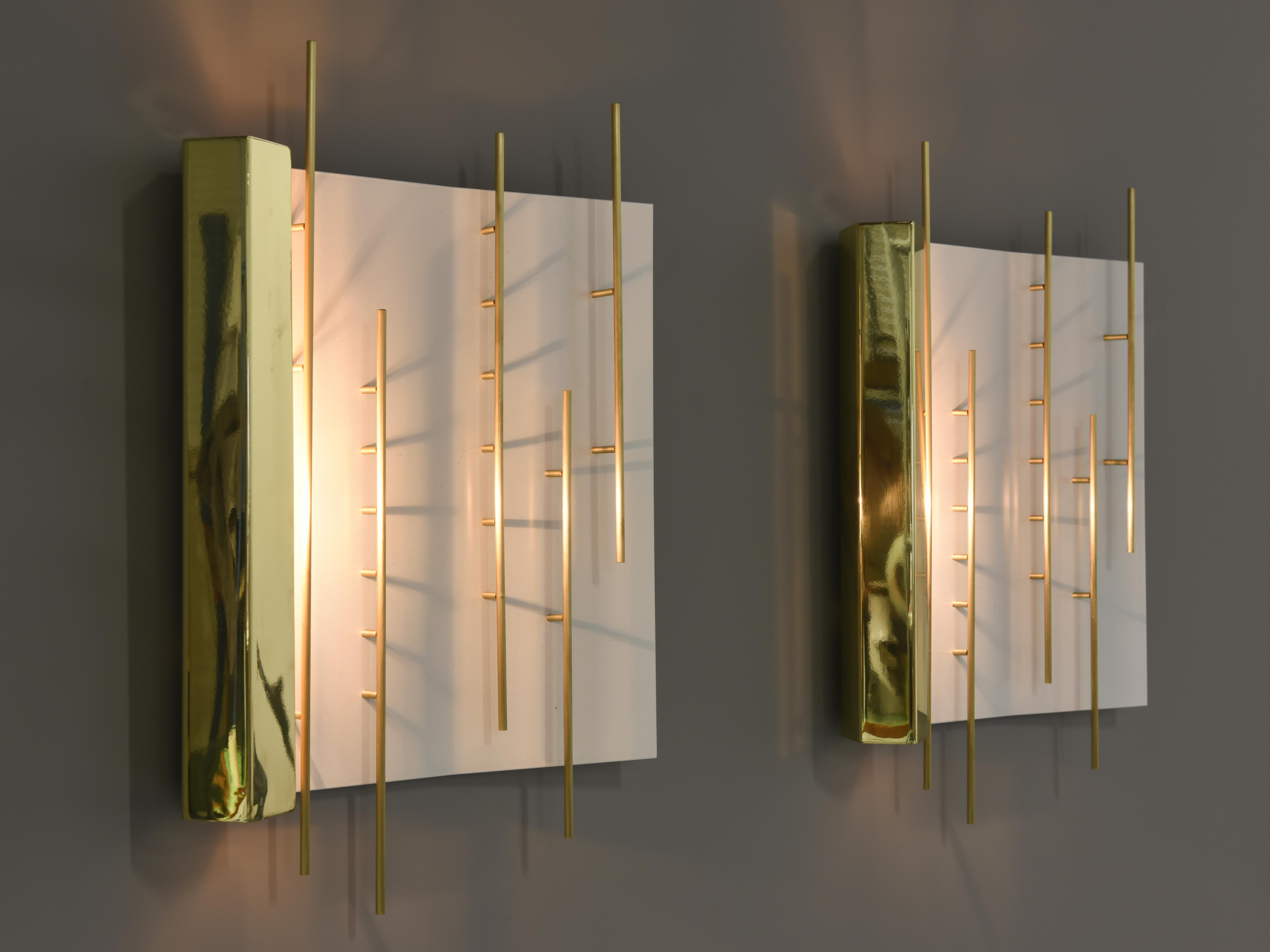 Elegant square wall sconces by the famous designer and architect from Italy.
Very graphic lamps in brass and lacquered metal. The light hidden on the left side creates play of light on the lamp and wall.

Signed with applied brass 