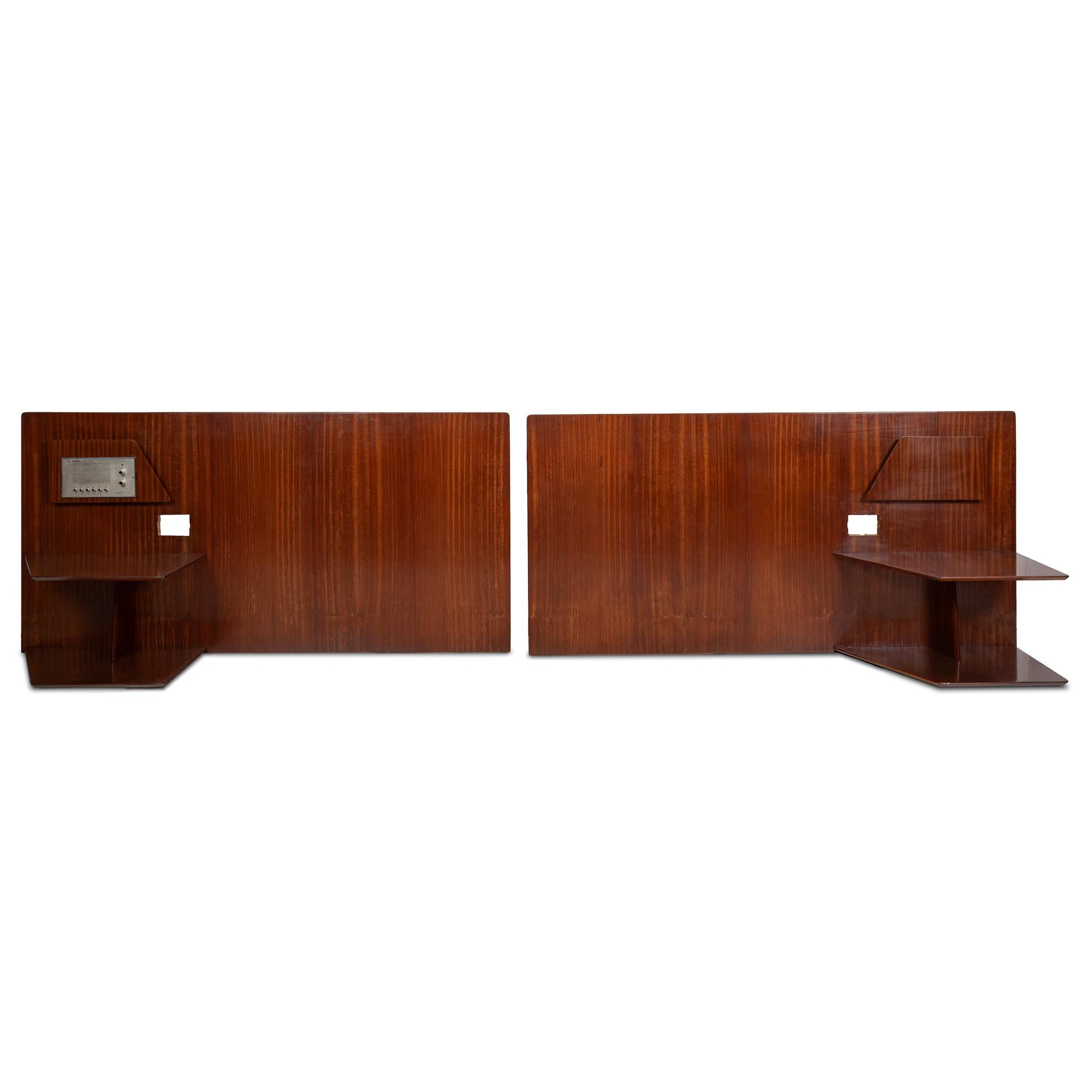 A pair of headboards by Gio Ponti from the furniture of the Hotel Royal in Naples, 1955.
Manufactured by Giordano Chiesa by Dassi.
walnut  and metal
two tiered shelving, magazine rack, space for lighting and two radio unit ( not working).
Good