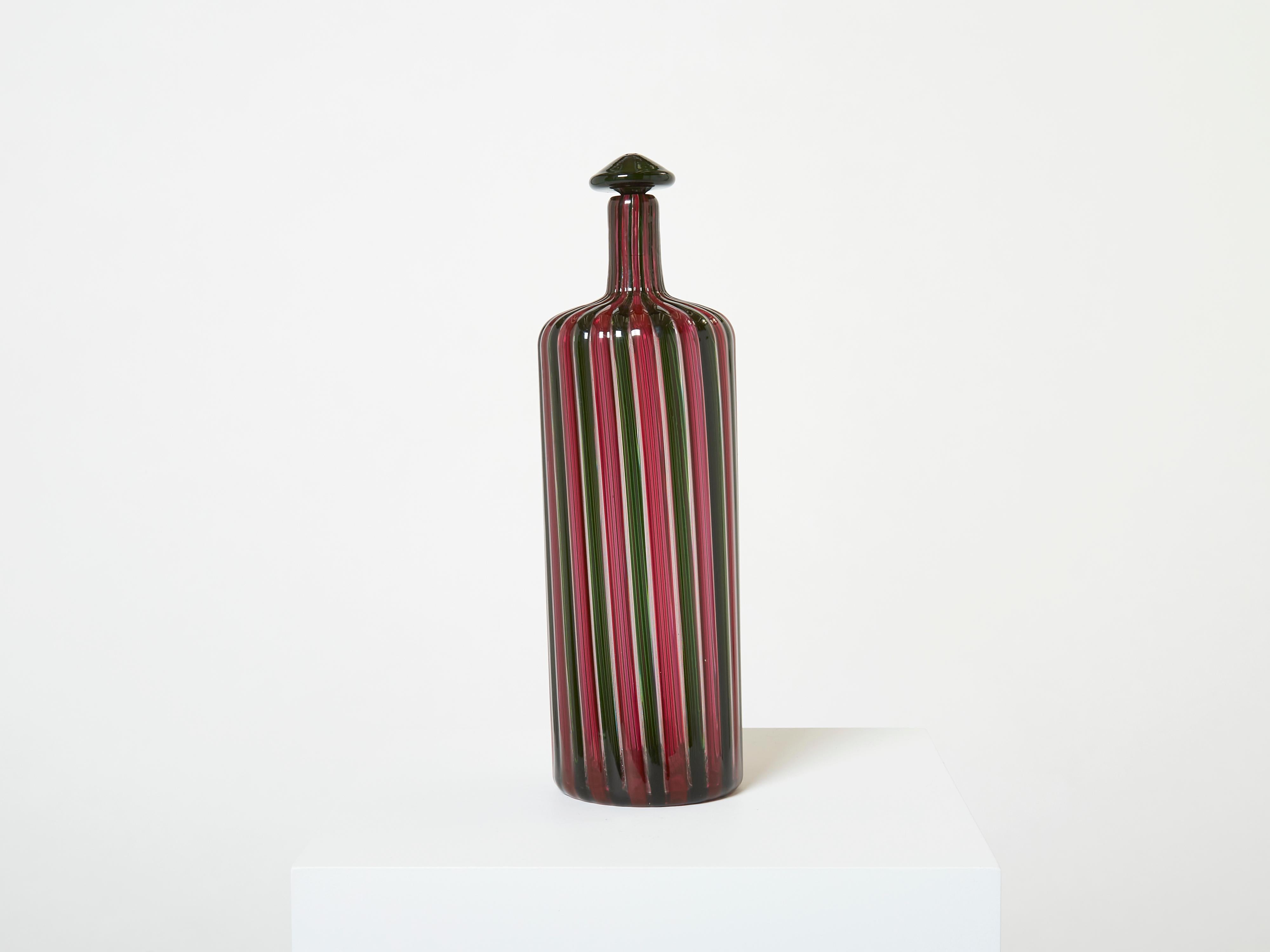 Rare Gio Ponti and Paolo Venini bottle for Venini designed in the 1950s, “ A Canne” model from the Morandiana series. This example is a 1980s edition, signed Venini 82, with its original stopper. This beautiful murano piece has eye-catching colors,