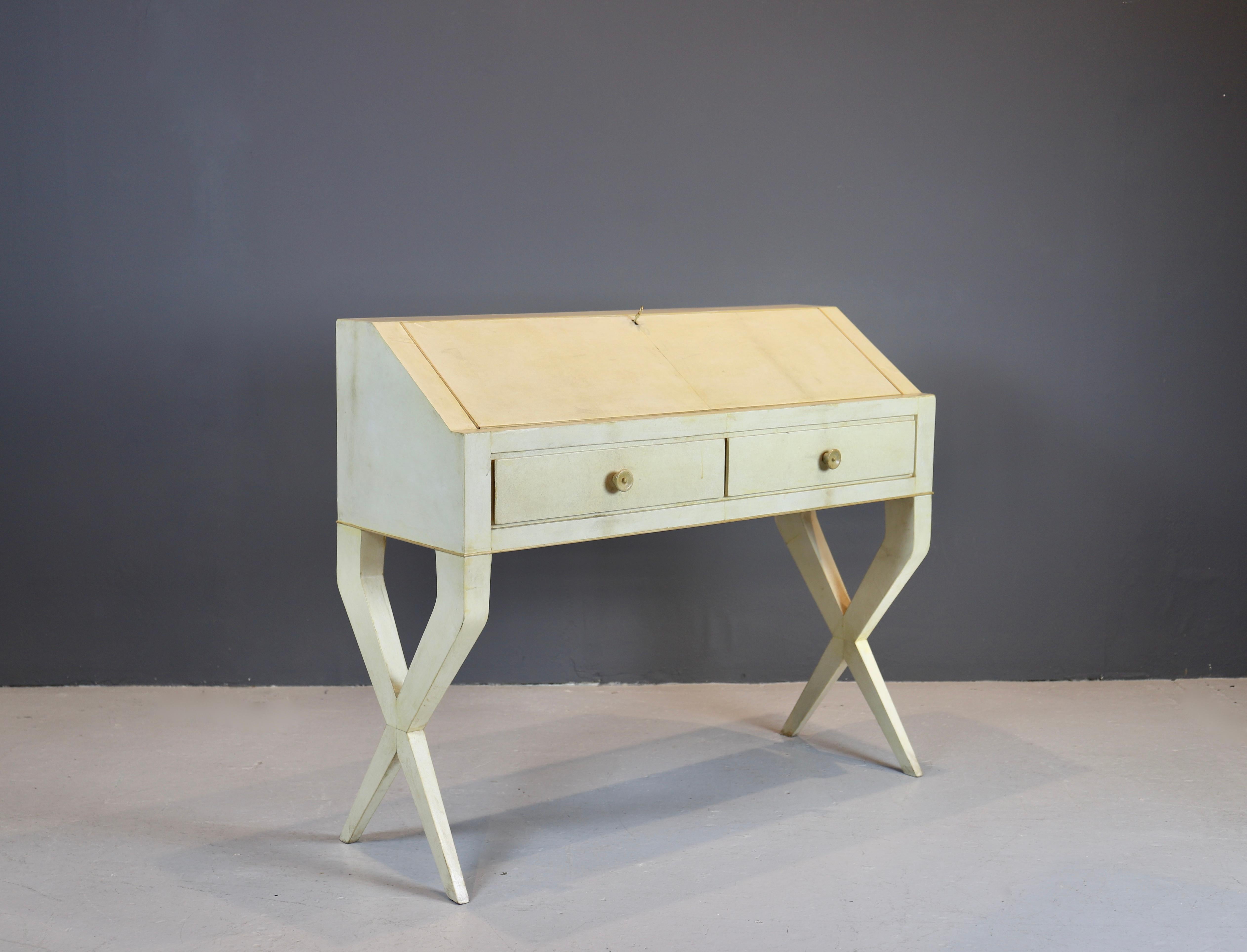 Gio Ponti secretary.
Italy, circa 1938.
Vellum over wood, Italian walnut, lacquered wood, brass .
Secretary features two drawers and a drop-front writing surface concealing storage. 
Sold with a certificate of expertise from the Gio Ponti