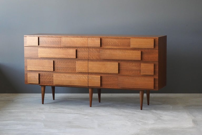 An iconic and rare double dresser / cabinet. Designed by Gio Ponti in his signature style where the grips of the drawers form a highly modernist ornamentation. Production of studio-level quality carried out in the 1950s by M. Singer & Sons, New