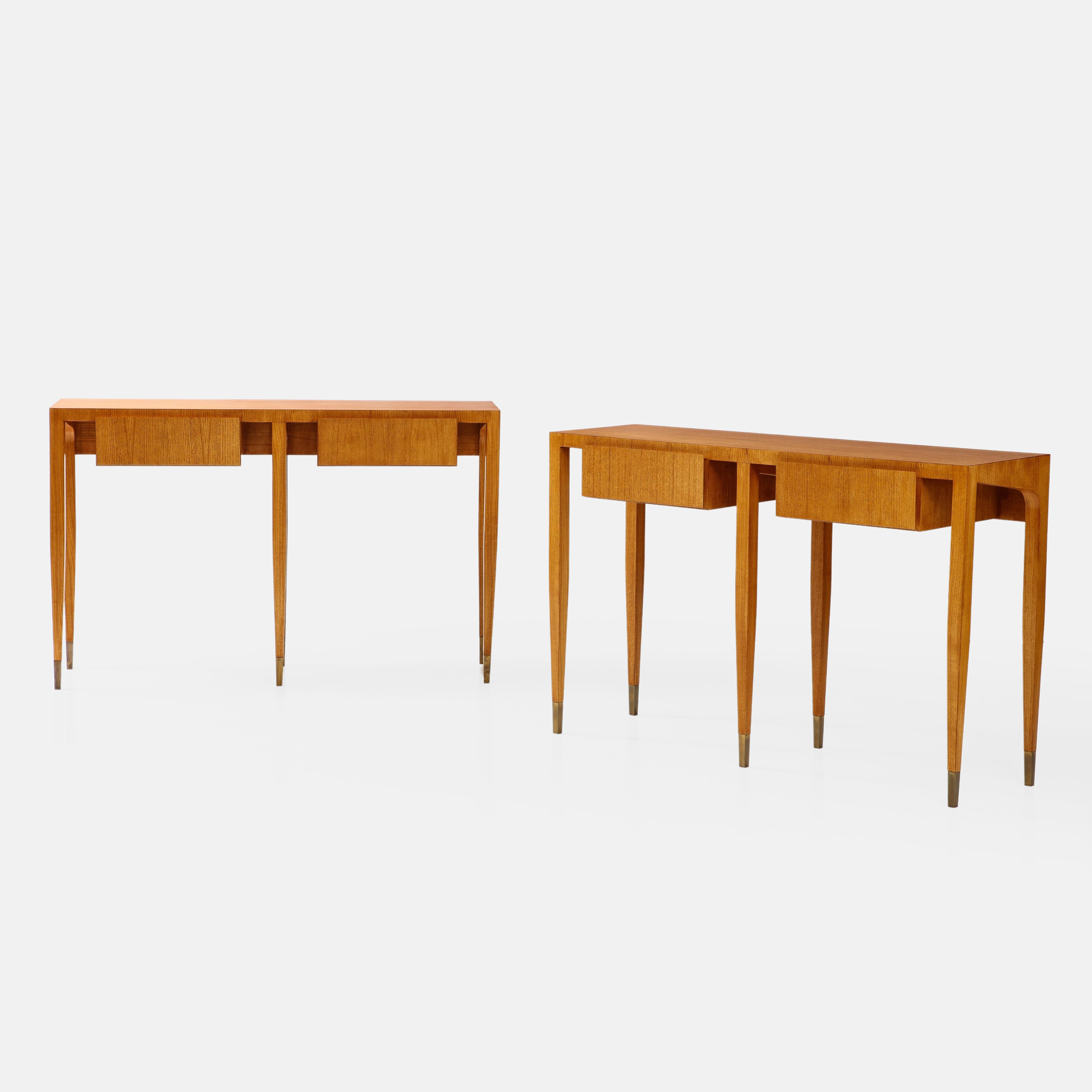 Gio Ponti for Giordano Chiesa rare and important pair of ash wood console tables each with two drawers and six legs ending in brass sabots, Italy, circa 1955.  These exquisite sculptural consoles have fine details throughout and clean architectural