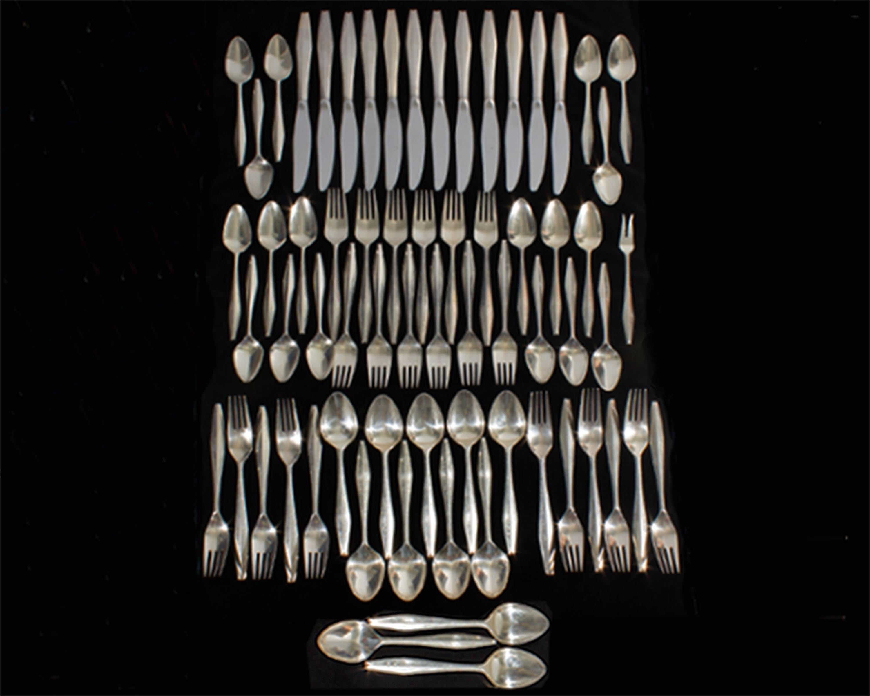 A set of sterling silver flatware designed by Italian designer Gio Ponti (1891-1979) for Reed & Barton. This set of flatware is in the Diamond pattern, a pattern originally introduced in 1958. The solid sterling pieces are marked 