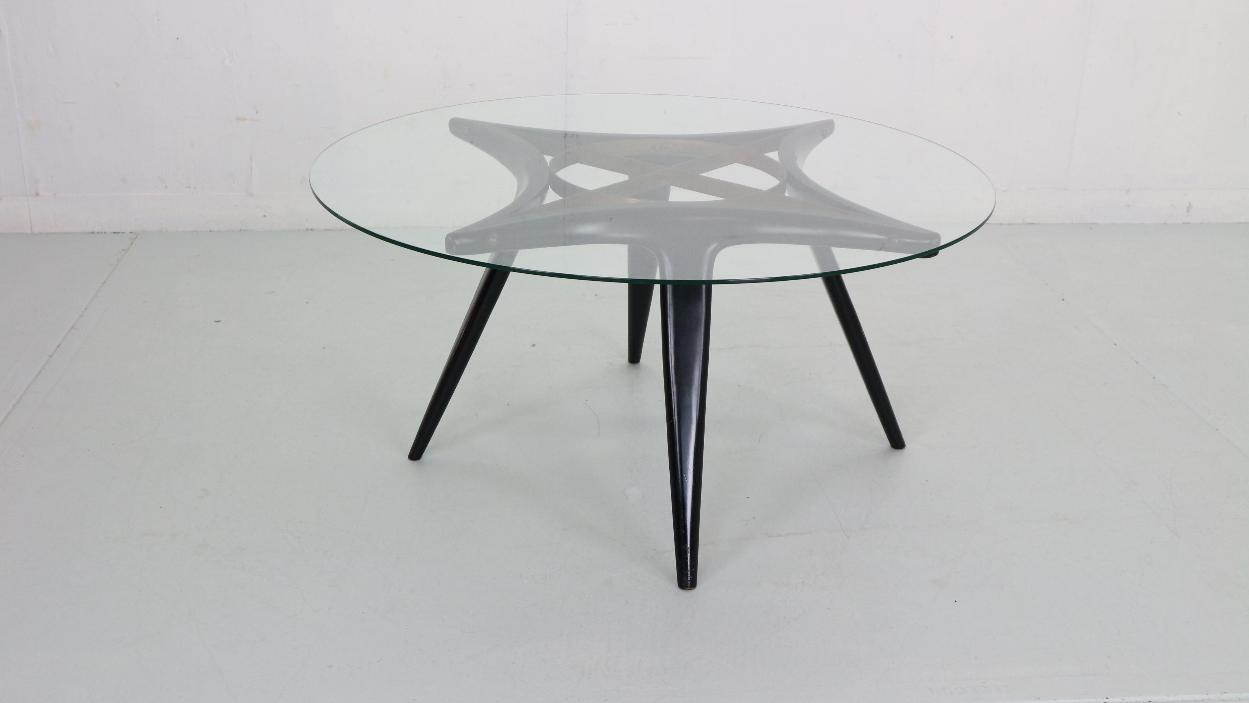 Mid-Century Modern period coffee table designed by famous Italian furniture designer Gio Ponti and manufactured by Singer& Sons in 1950s period, Italy.
Round shaped coffee table is made of solid walnut wood- lacquered black, brass shaped details