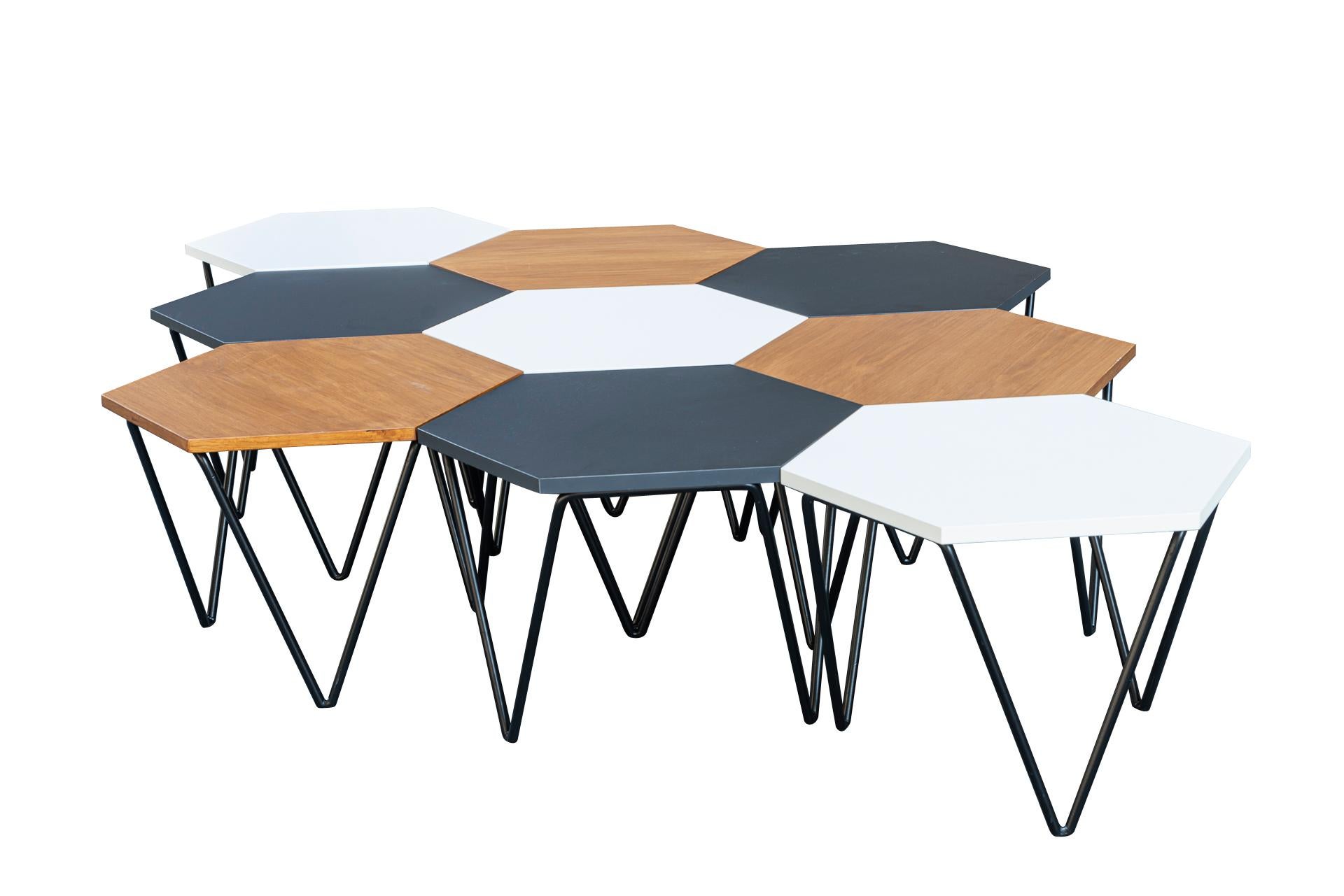 Gio Ponti, 
Set of 9 coffee tables, 
3 black laminated, 3 white laminated, 3 wood,
Black painted iron foot,
Edition ISA, 
Italy, circa 1970.

Measures: (One Table) diameter 58 cm, height 40 cm.
(Full Set) width 235 cm, depth 152 cm, height