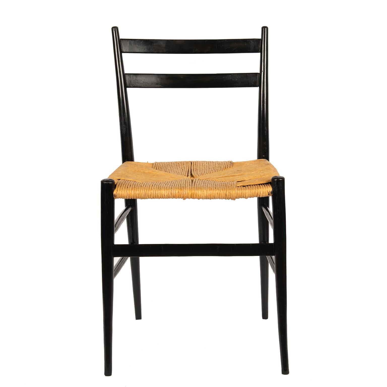 These iconic chairs by Italian design master Gio Ponti are made of black lacquered wood with rush seats.
They are structurally stable and in very good vintage condition. I am offering 6 for sale.