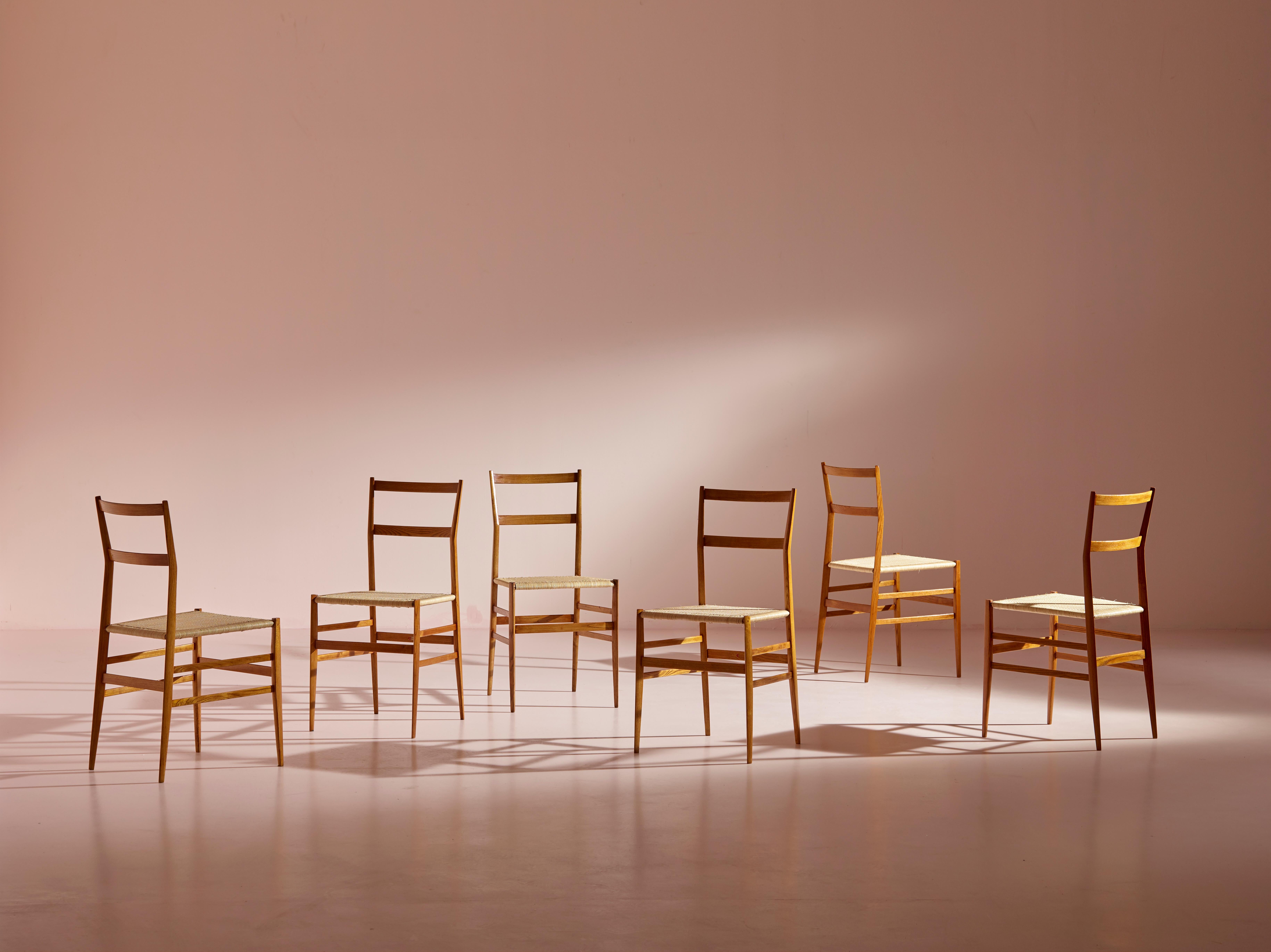 A set of six Superleggera chairs, produced by Cassina in the early 1960s and designed by Gio Ponti, has undergone professional restoration while preserving and refinishing their ash frames in the original color. The old woven straw seats have been