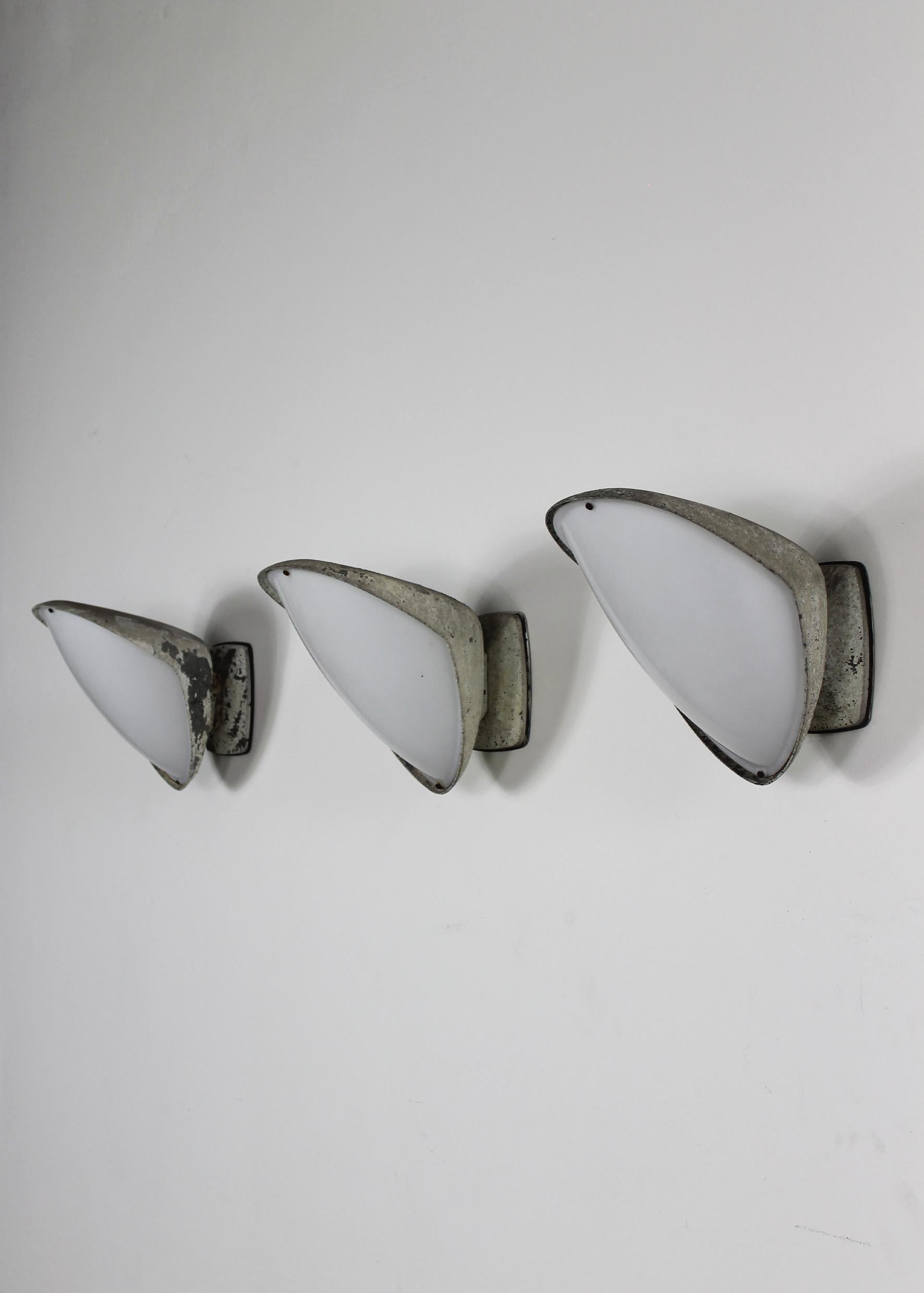 Set of three wall lights with structure in white lacquered aluminum and opaline plexiglass lampshade, also suitable for outdoor use. 

Designed by Gio Ponti and manufactured by Ditta Greco in 1960s.

Gio Ponti was an icon of the modernist