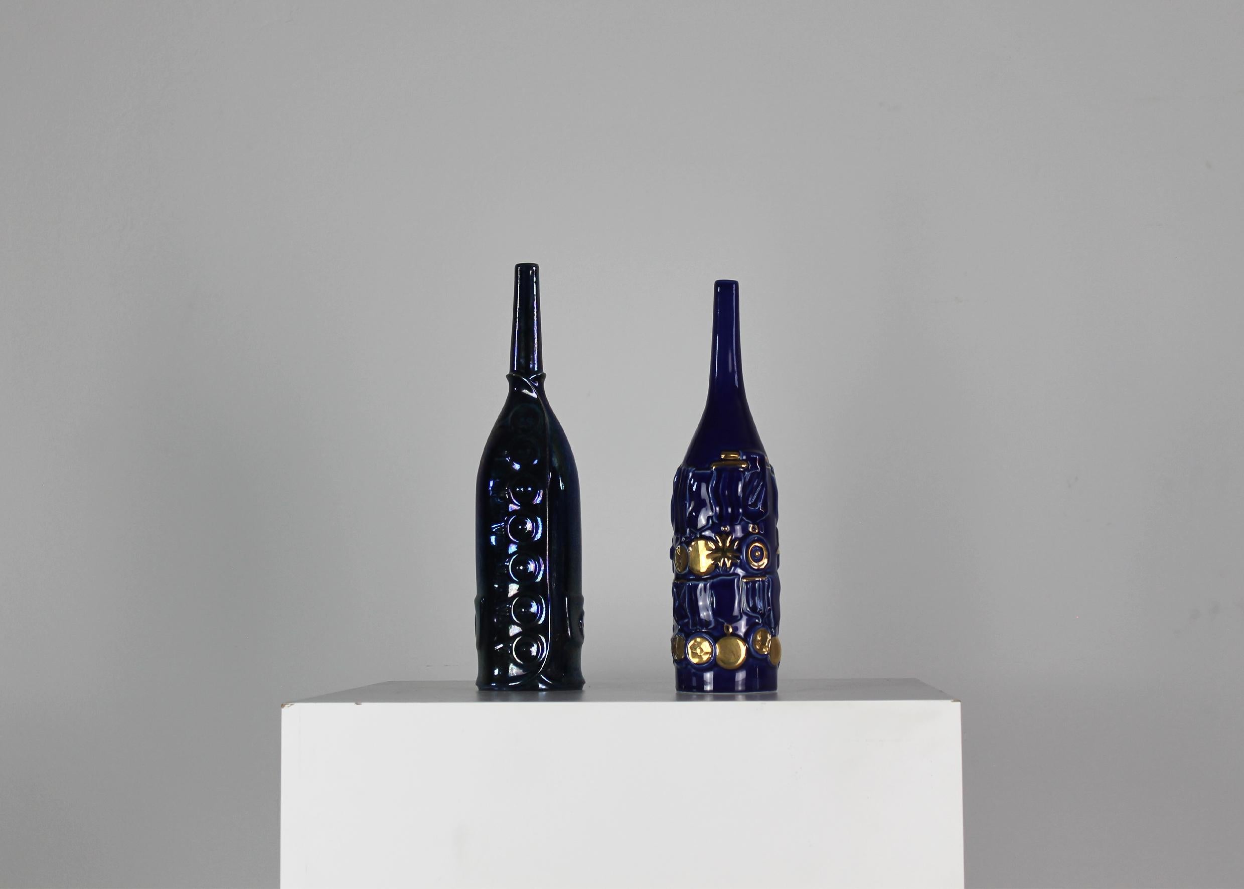 Set of two decorative blue bottles in ceramic with gold lusters decorations (realized by Bottega Gatti in Faenza) from the Bottiglie Abitate series which is designed by Gio Ponti in the 1950s and manufactured during the 1990s by Cooperativa Ceramica