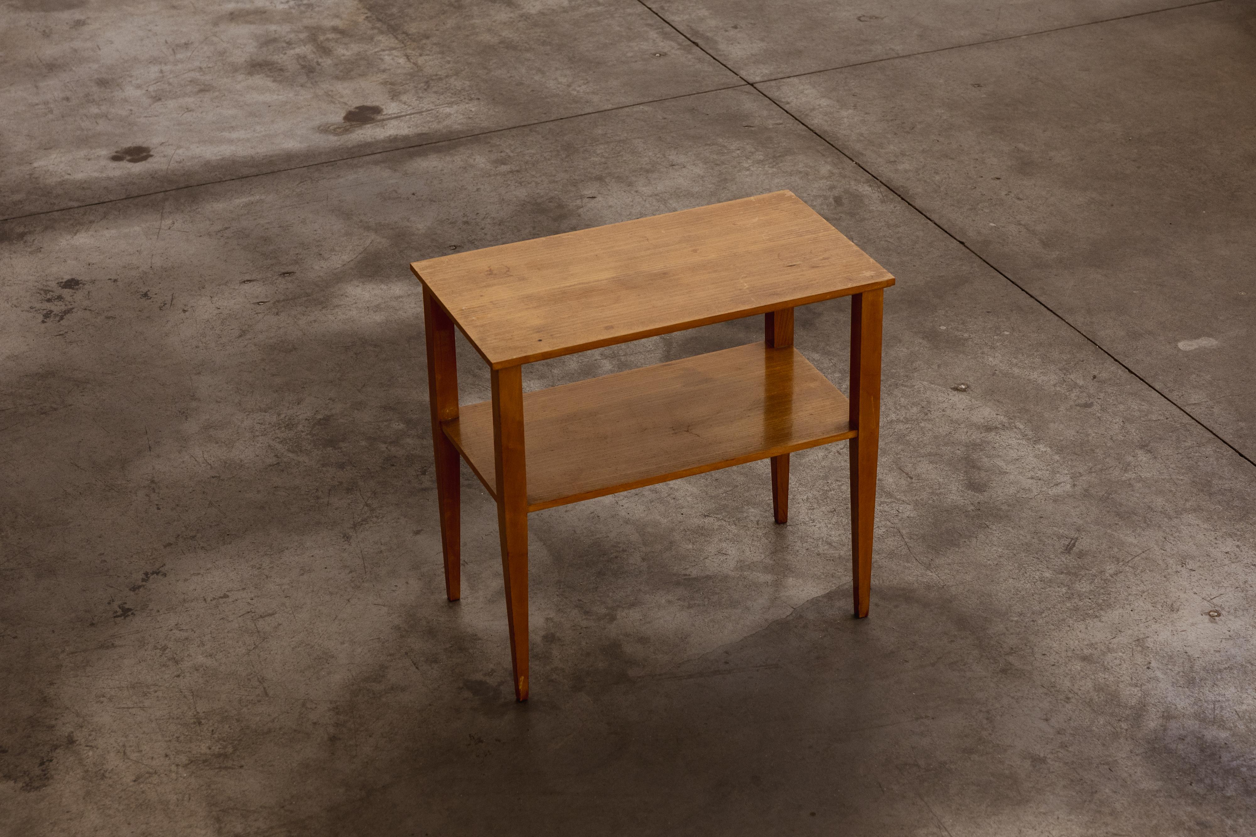 Gio Ponti side tables, wood, Italy, 1950s, set of 2

Side table designed by Gio Ponti in the 1950s, featuring an elegant and essential construction. The table is crafted in light-stained wood, with a rectangular top, tapered legs, and an additional