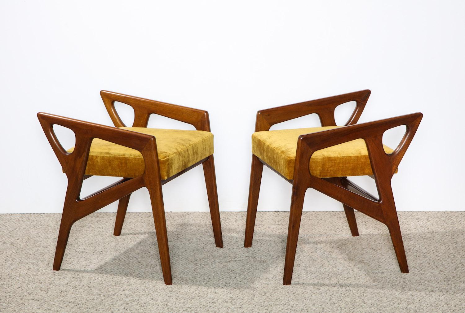 Rare pair of sculptural stools by Gio Ponti. Fantastic angular forms in walnut with gold velvet upholstered seats.