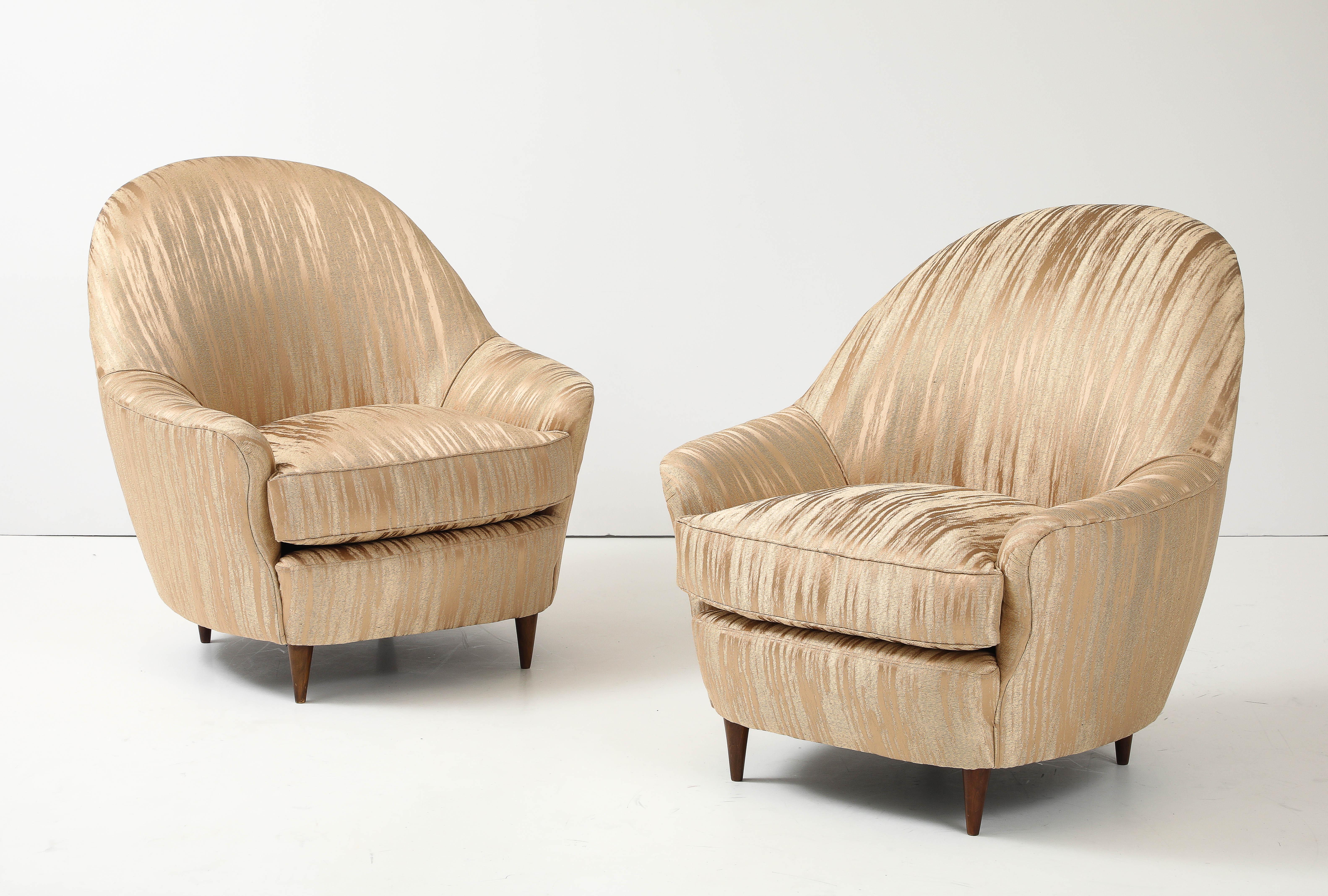 1950's Mid-Century Modern Italian lounge chairs in the style of Gio Ponti, newly re-upholstered with solid walnut legs, with minor wear and patina due to age and use.