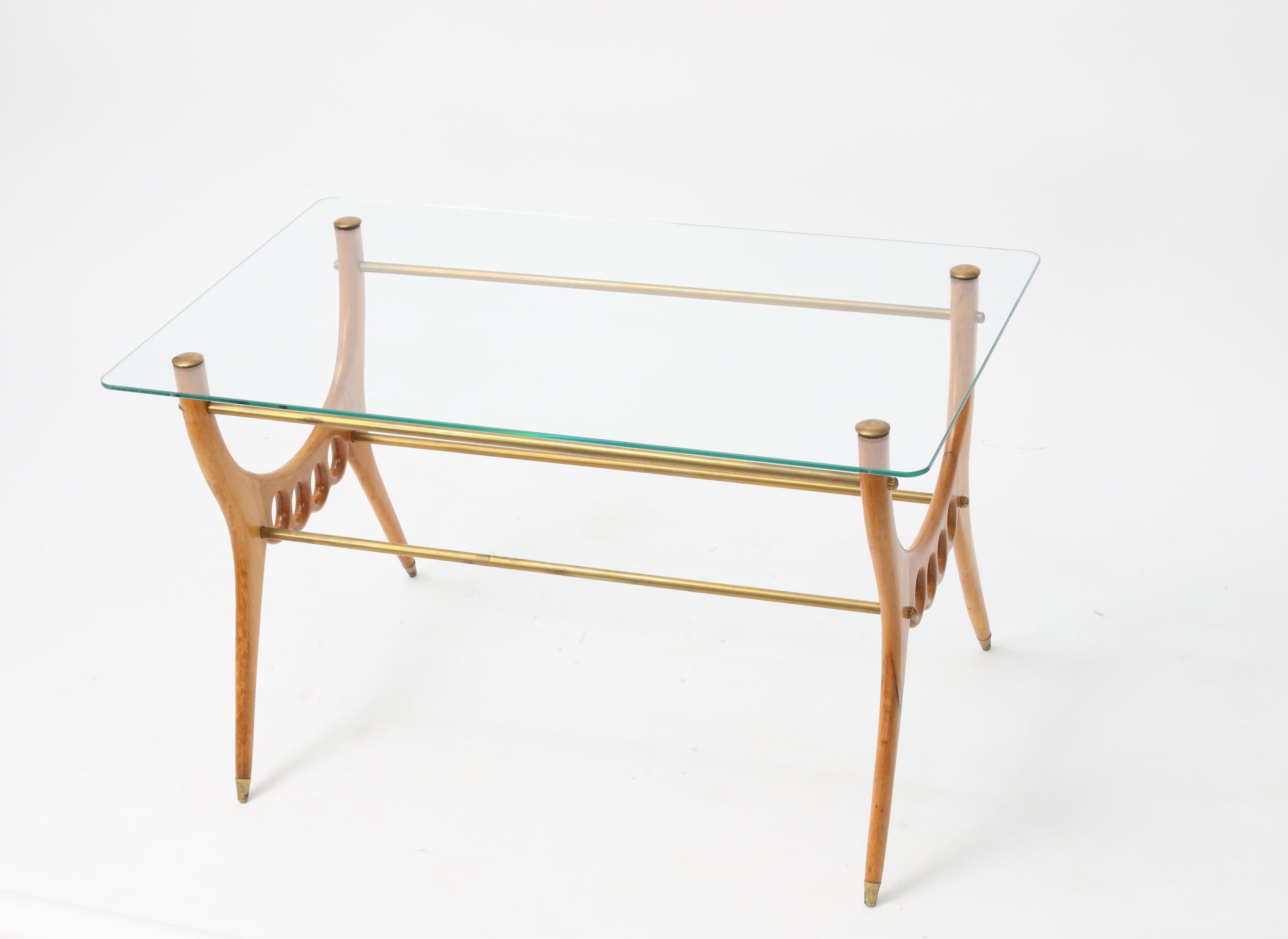An Italian exquisite oak, glass top and brass fittings coffee table in the manner of Gio Ponti. Italy 1960s
