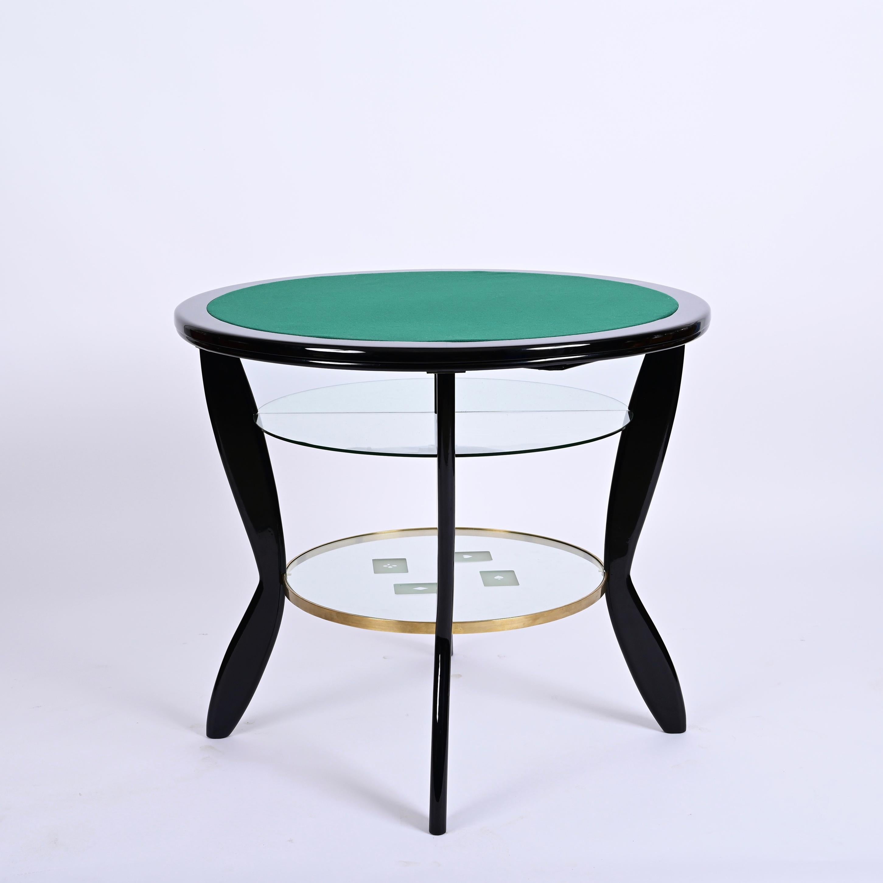 Incredible midcentury round ebonized beech and brass game table with two glass shelves. This fantastic table is designed in the style of Gio Ponti and was produced in Italy during the 1950s. 

This piece is an authentic masterpiece: a breathtaking