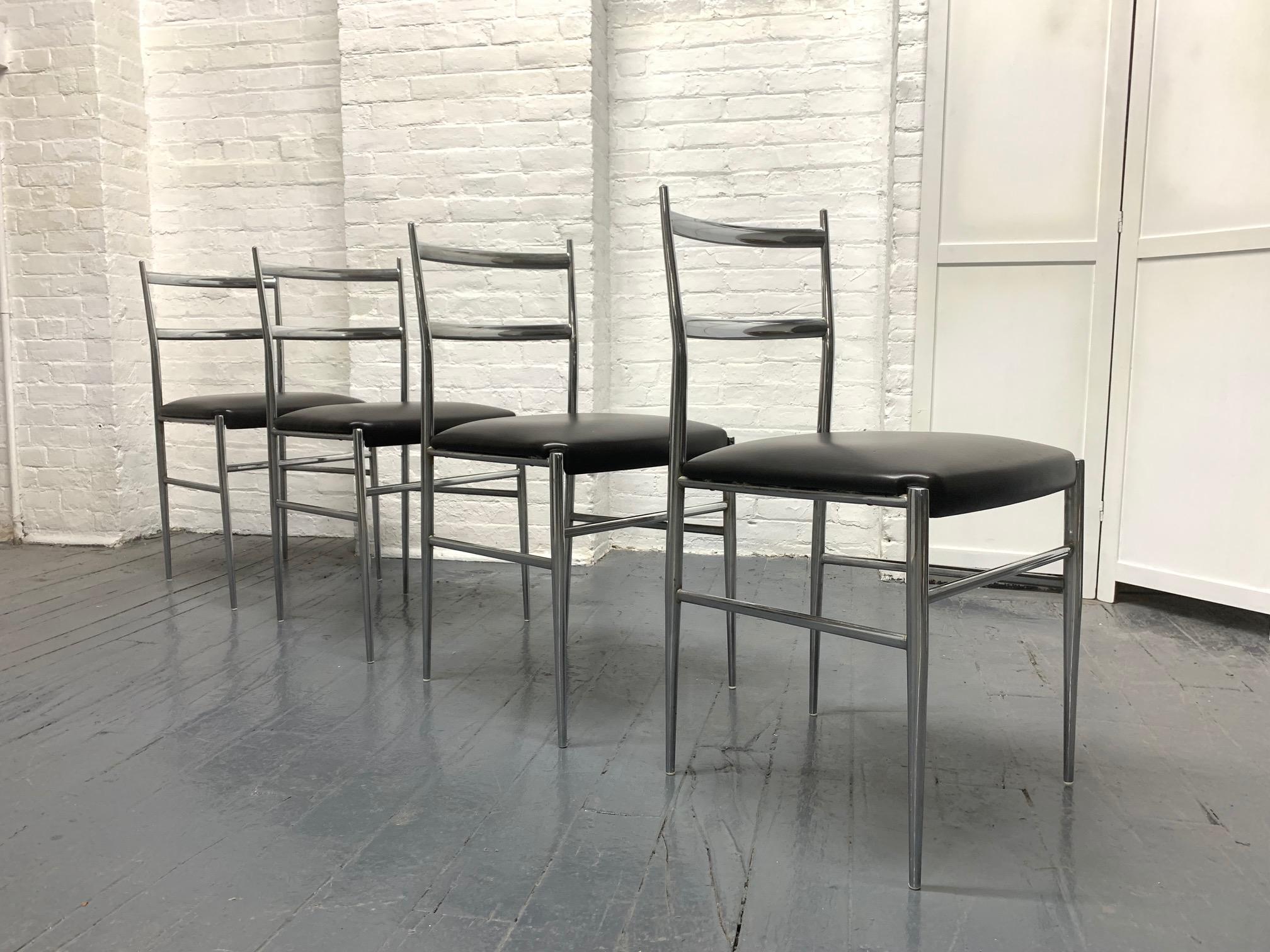 Set of four Gio Ponti style Italian chrome chairs. The seats of the chairs are black vinyl and marked 