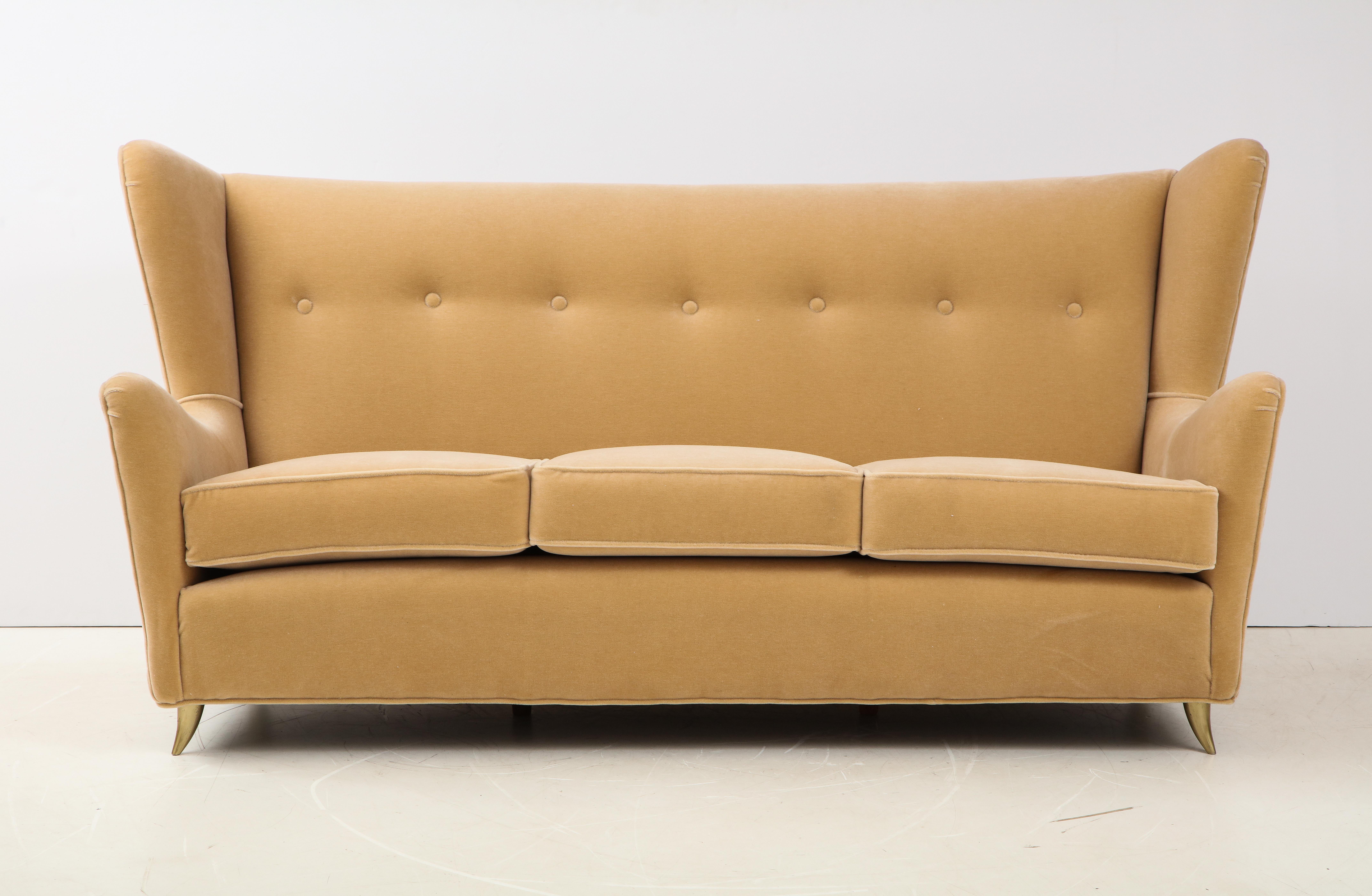 Stunning 1950s Italian wingback sofa with brass legs in the of Gio Ponti. Newly upholstered in mohair fabric.