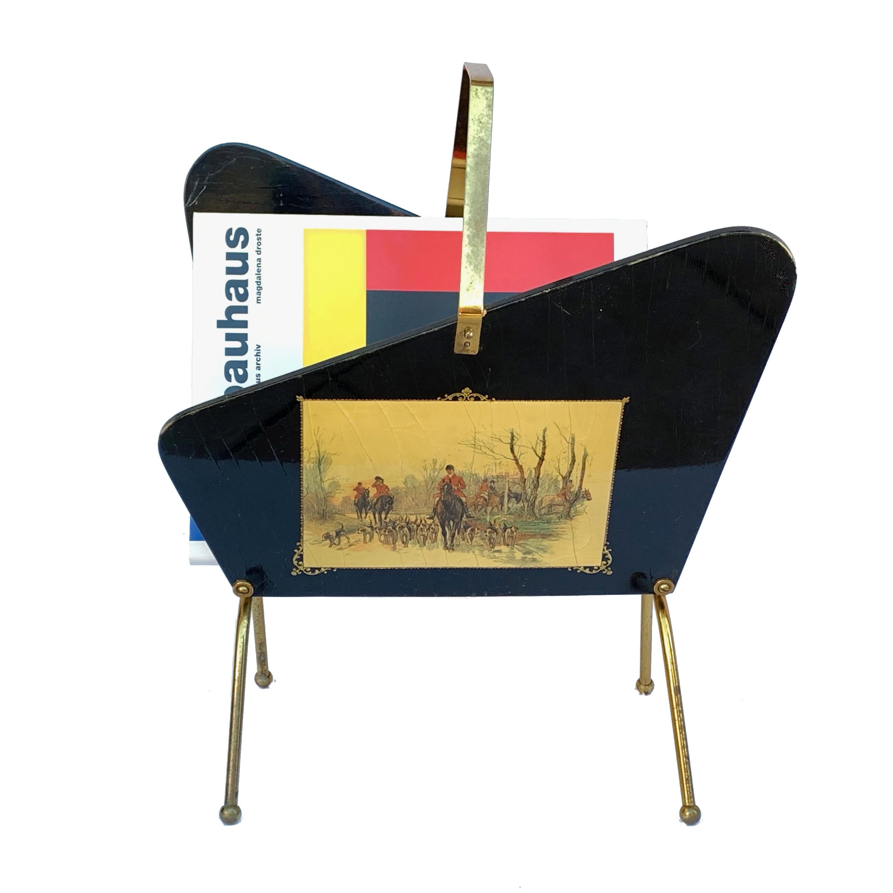 Gorgeous folding magazine rack from the 1950s in ebonized wood and brass.
It has two prints depicting scenes of fox hunting