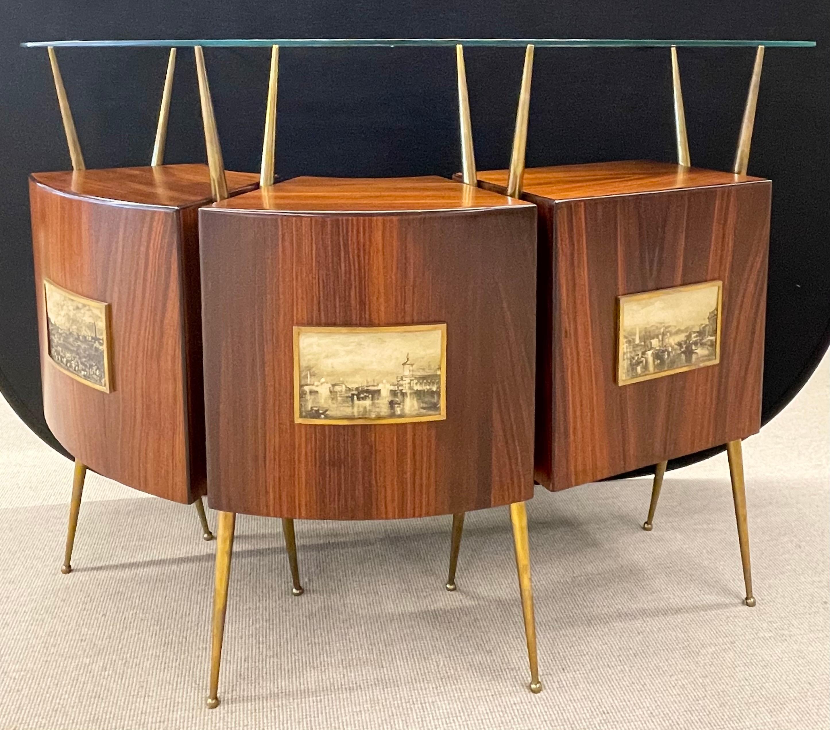 Modern dry bar in the style of Gio Ponti Italian rosewood dry bar Modern dry bar in the style of Gio Ponti 
45 1/2 x 56 x 14 inches with three cabinets, sculpted brass legs, glass top, and photo inlays, c. 1950.