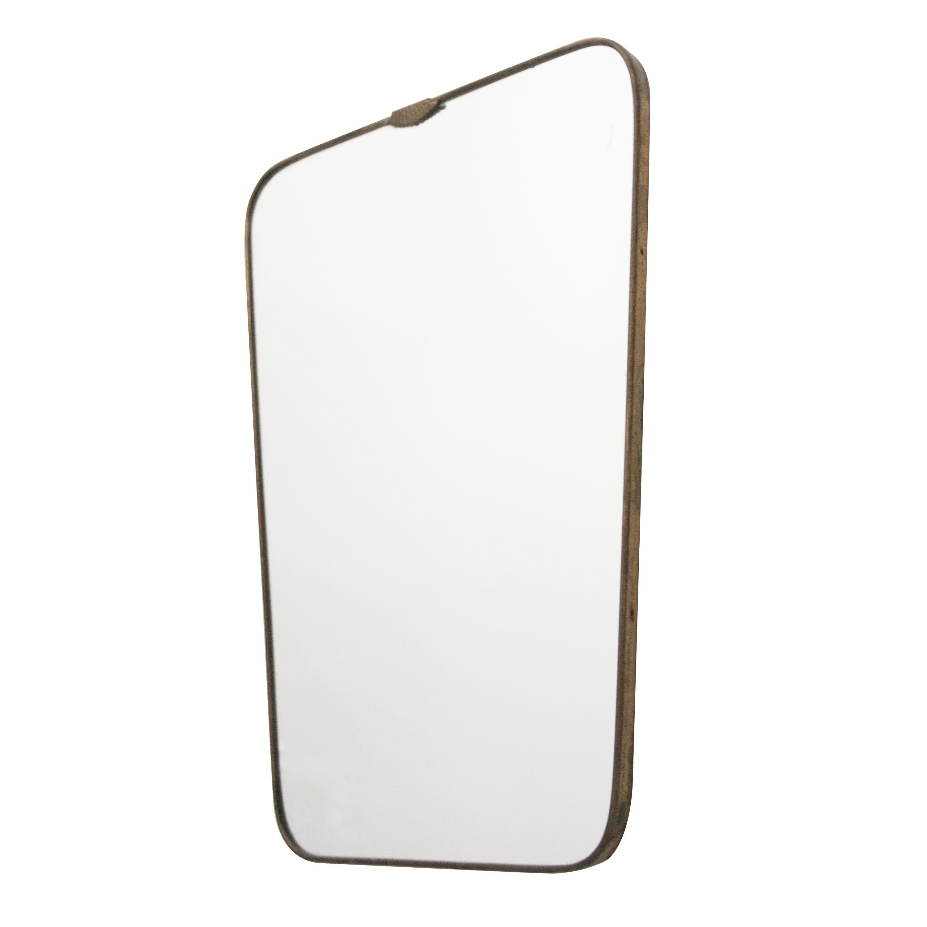 Gio Ponti style mirror, shield form with brass structure.
  