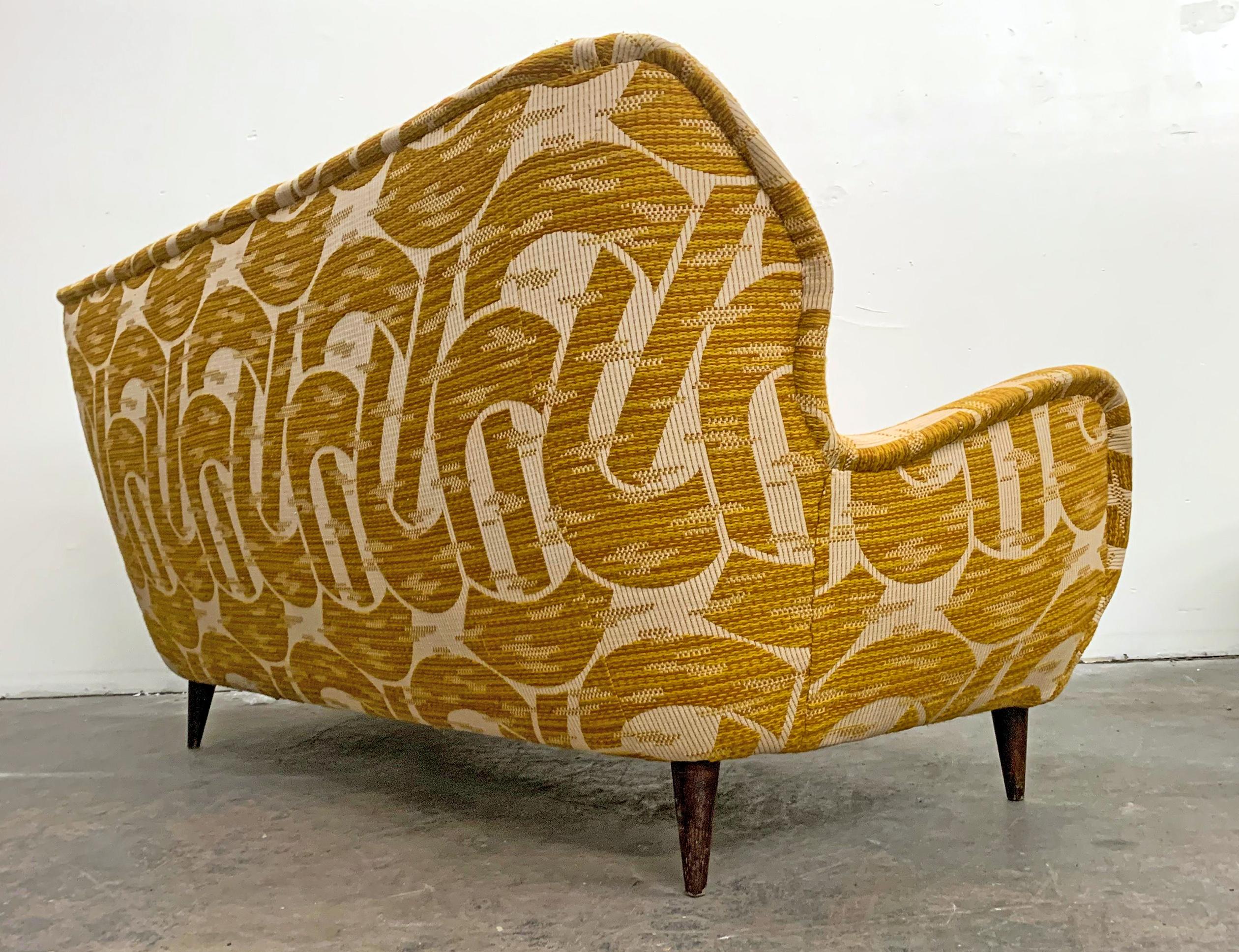 Available right now we have this gorgeous sofa in the style of Gio Ponti for Edizioni ISA, Bergamo, circa 1952. This sofa features everything a Mid-Century Modern collector or design aficionado could dream-- swooping curvy lines, a rounded chonky