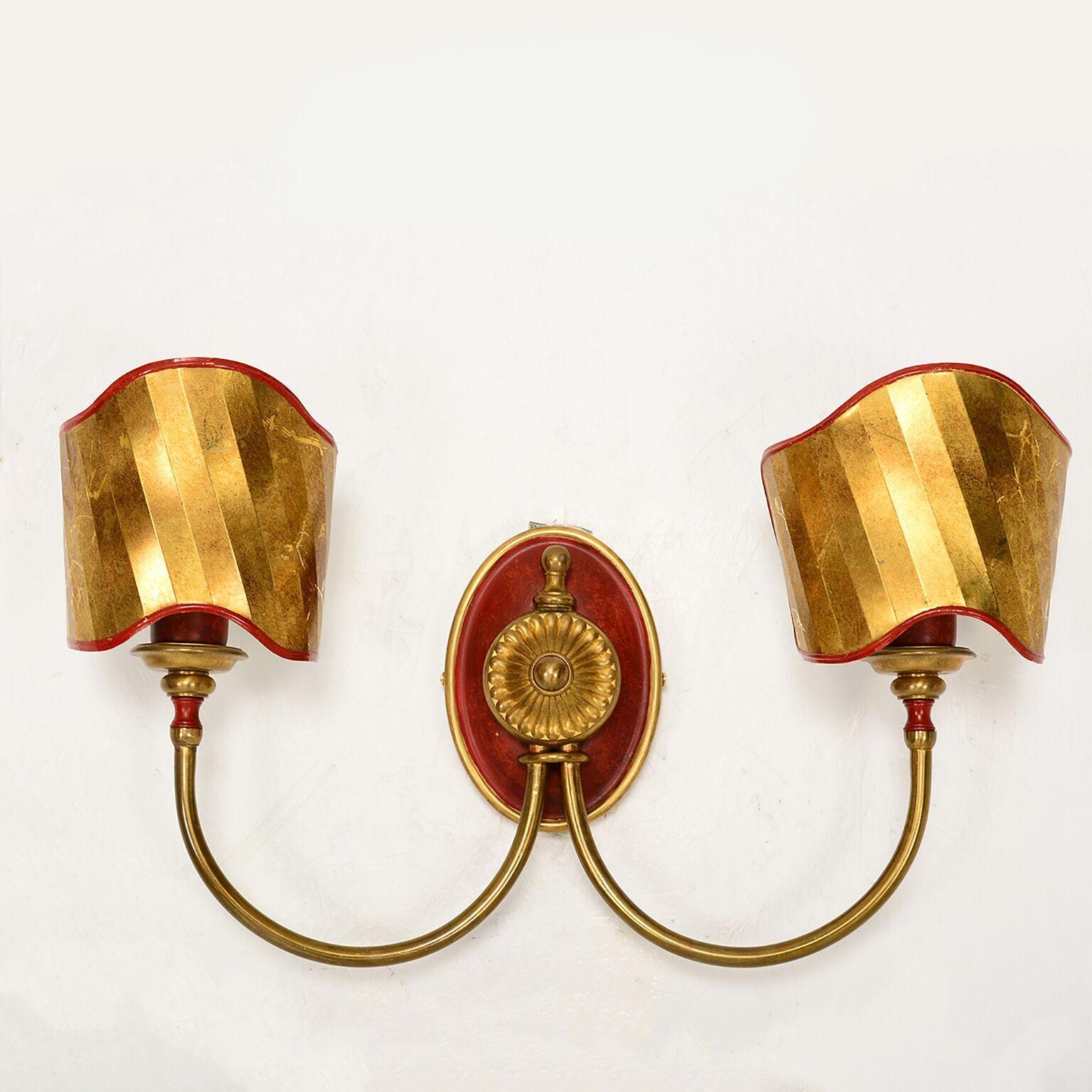 For your consideration: an elegant pair of Italian wall sconces with decorative brass shield.
In the Style of Gio Ponti.  Circa 1980s 
Measures: H 13 in. x  W 20.13 in. x  D 5.38 in. 
Original Vintage Condition. Refer to images.  Expect vintage