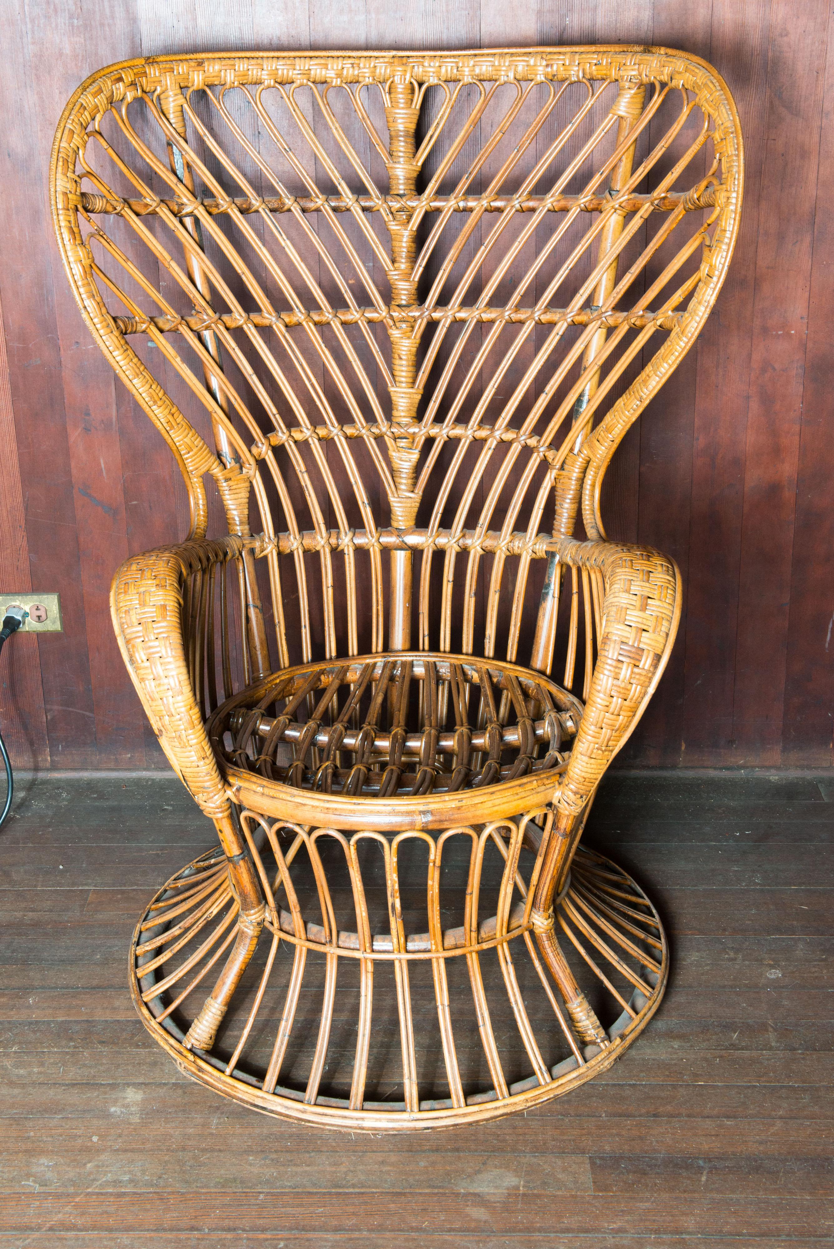 Mid-Century Modern vintage rattan wingback arm chair in the style of the Gio Ponti chair designed circa 1948 in Italy and in production in the 1950s. This chair is in exceptionally good condition. Purchased in Paris.
Seat: 20